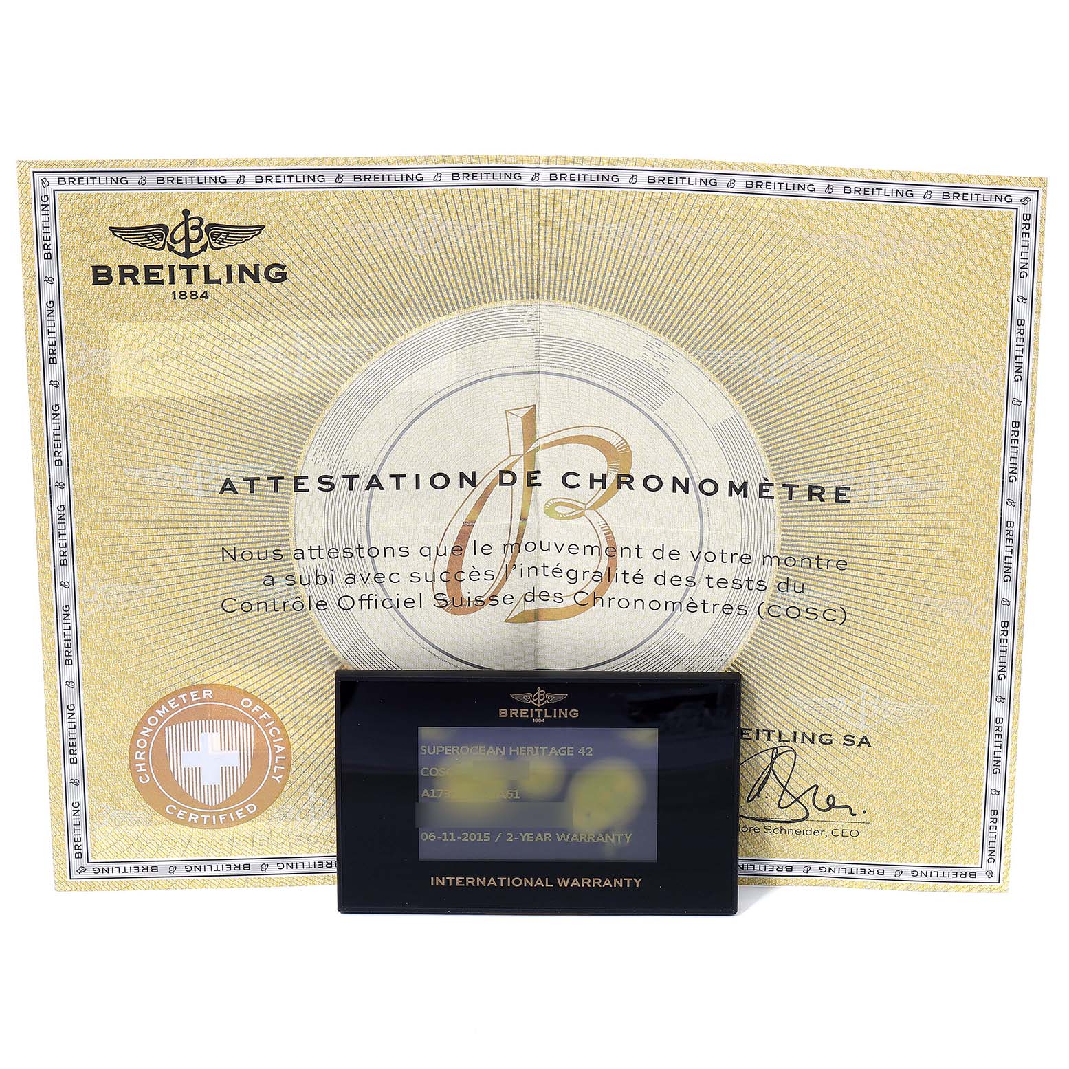 The image shows a Breitling Superocean A17321 Men
s Stainless Steel Black Dial A17321 Men
s Stainless Steel Black Dial model
s certificate of chronometry and international warranty card.