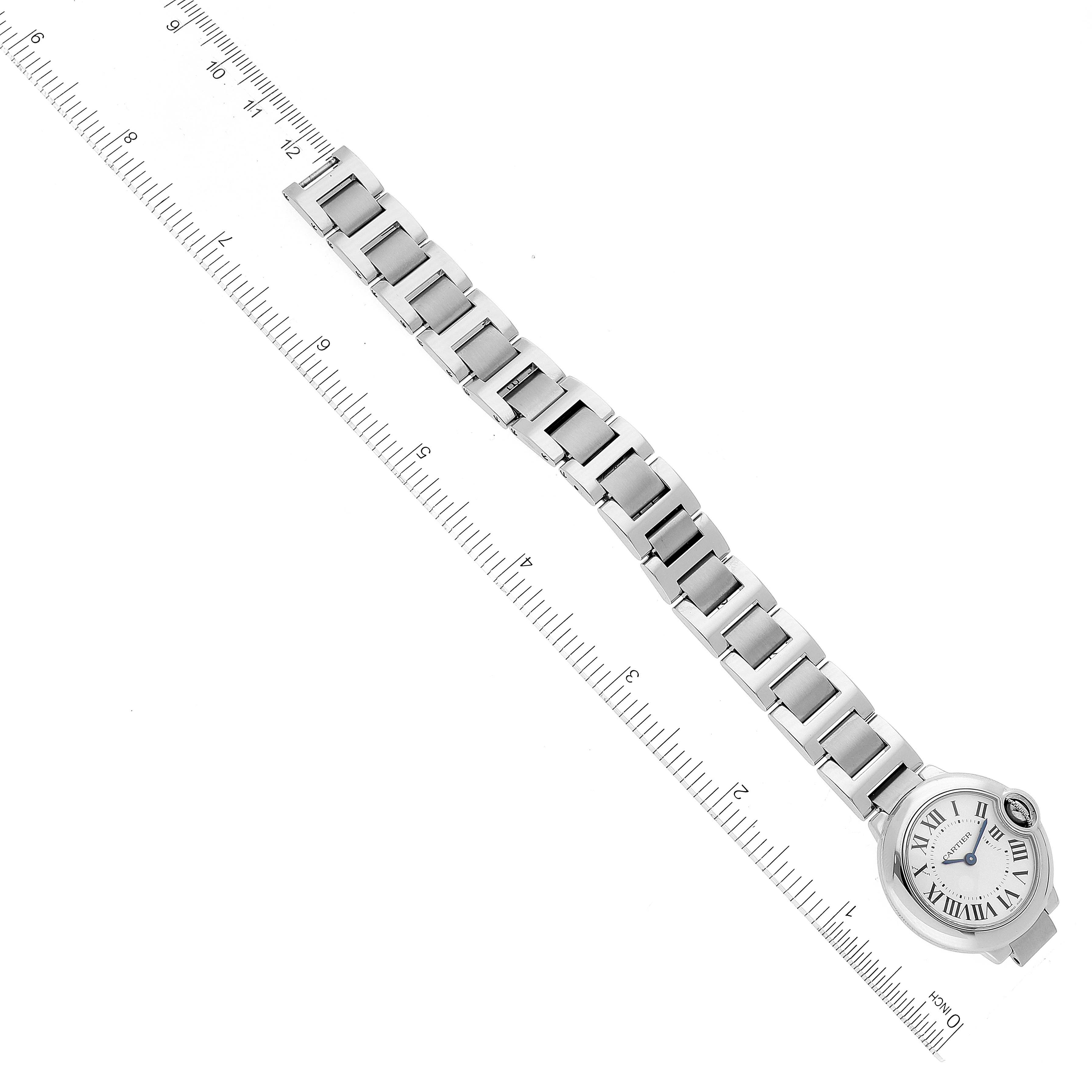 The image shows an overhead view of a Cartier Ballon Bleu W69010Z4 Women's Stainless Steel Silver Dial W69010Z4 Women's Stainless Steel Silver Dial watch, showcasing the face and the metal bracelet next to a ruler.