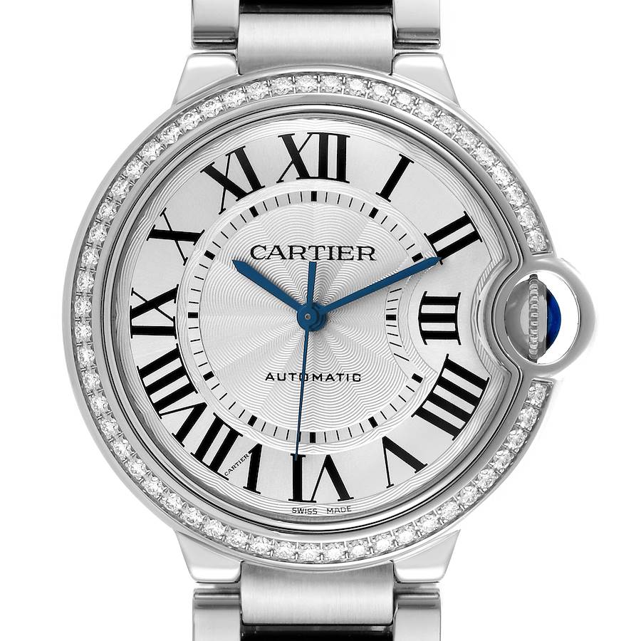 The Cartier Ballon Bleu watch is shown from a frontal angle, highlighting the dial, Roman numerals, and diamond bezel.