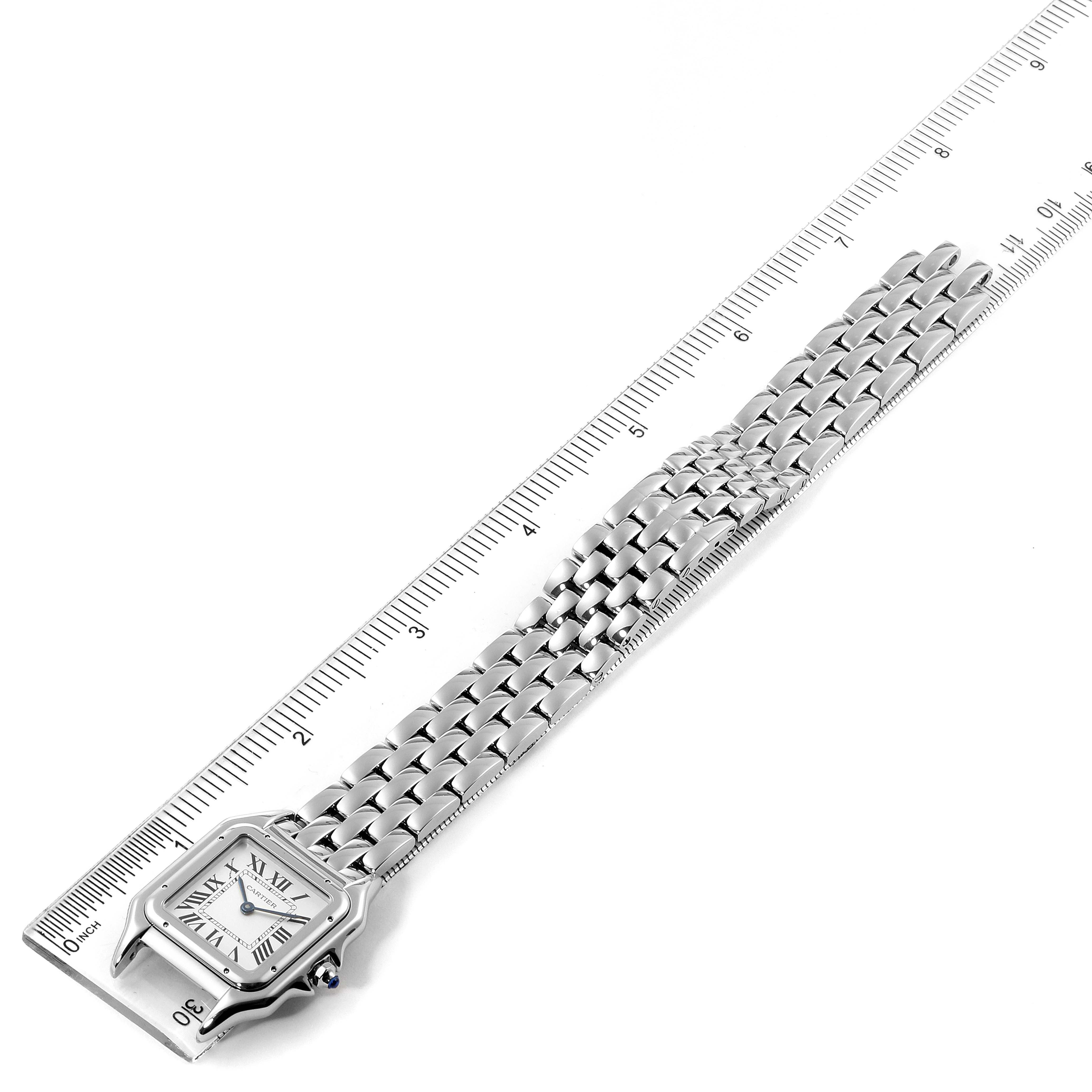 This image shows a Panthere Cartier watch laid flat with a ruler measuring its length and a clear view of the face and band.
