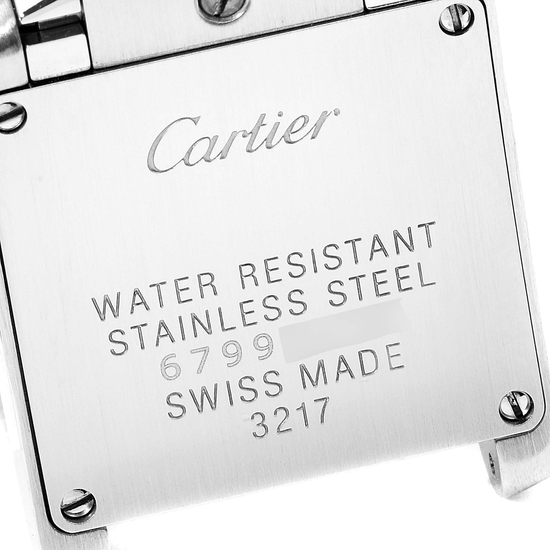 The image shows the back casing of a Cartier Tank Francaise W51008Q3 Women
s Stainless Steel Silver Dial W51008Q3 Women
s Stainless Steel Silver Dial watch, displaying brand, water resistance, material, and serial number.