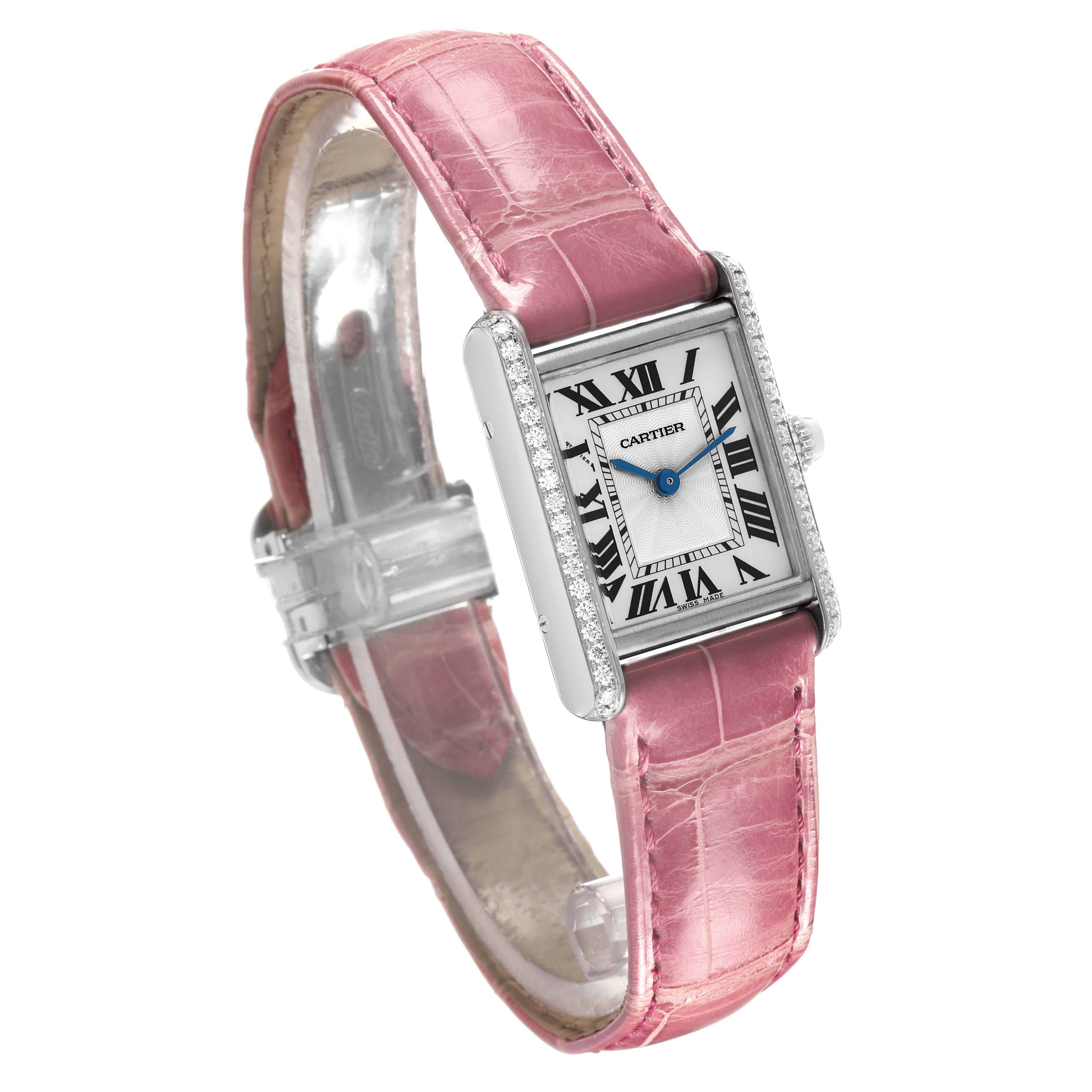 The Cartier Tank Louis WJTA0011 Women's White Gold Silver Dial watch is shown at a three-quarter angle, featuring a pink strap, rectangular face, and diamond accents.