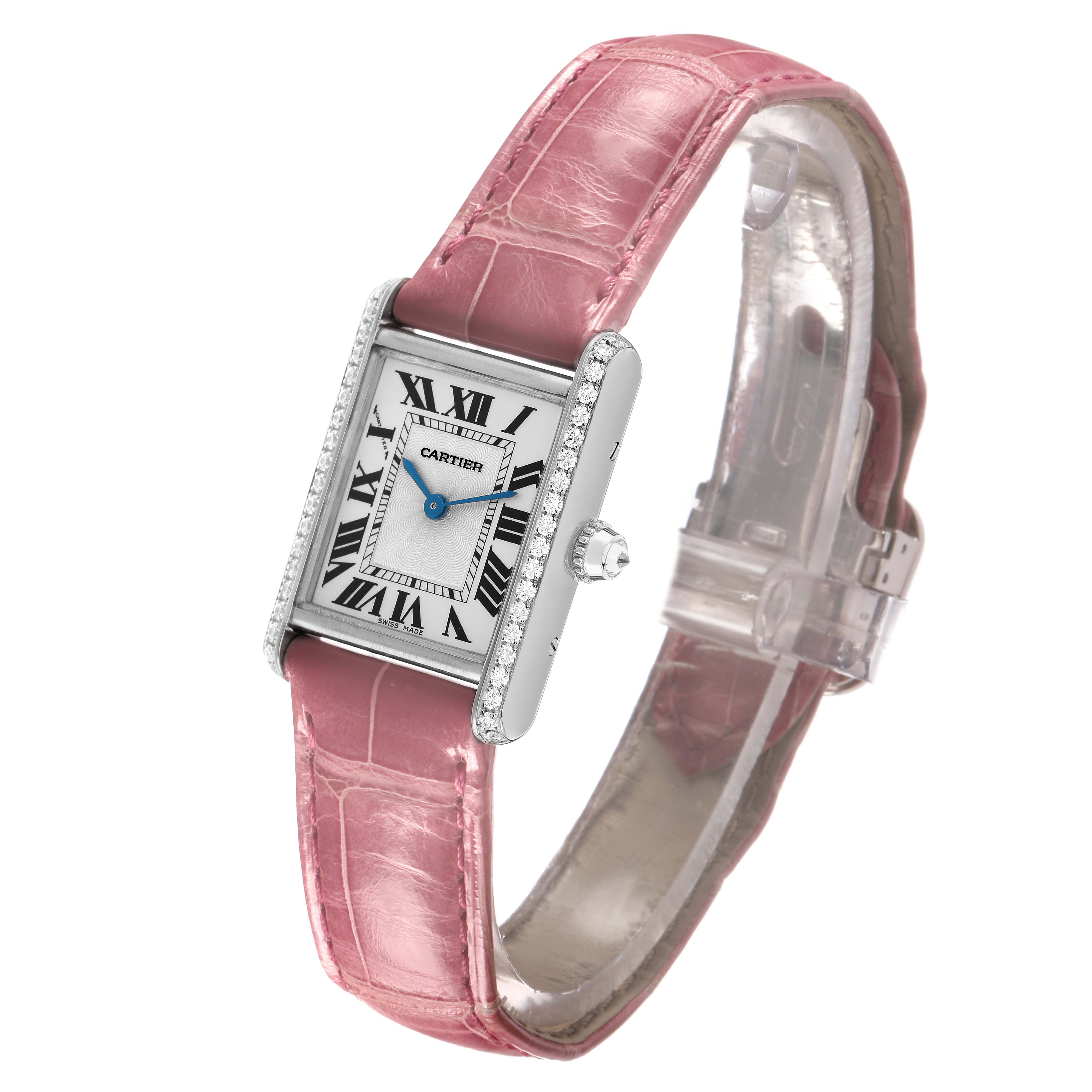 The Cartier Tank Louis WJTA0011 Women's White Gold Silver Dial watch is shown at a three-quarter angle, highlighting its rectangular case, pink strap, and diamond accents.
