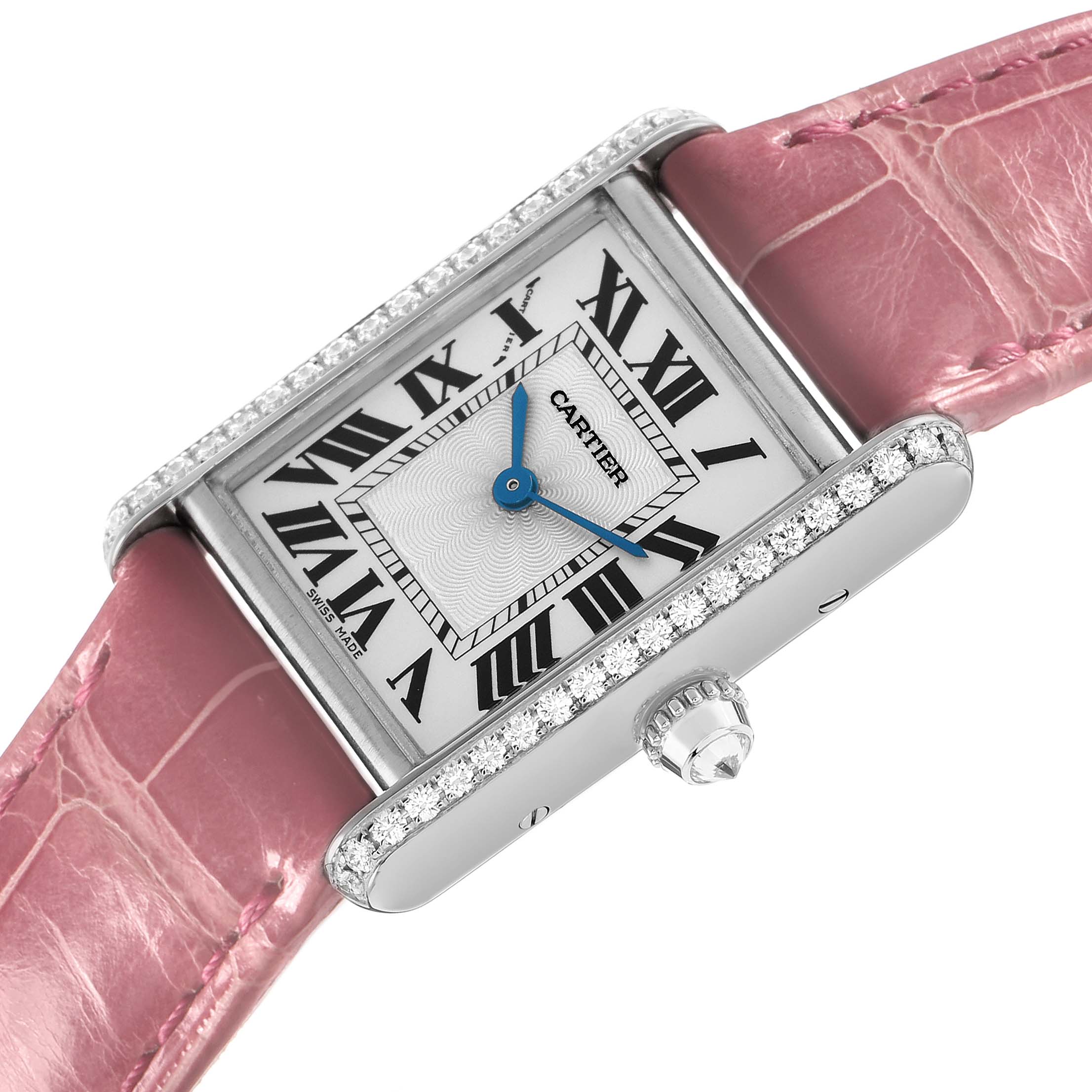 The Cartier Tank Louis WJTA0011 Women's White Gold Silver Dial watch is shown at an angled top view, highlighting its pink strap, diamond-set bezel, and Roman numeral dial.