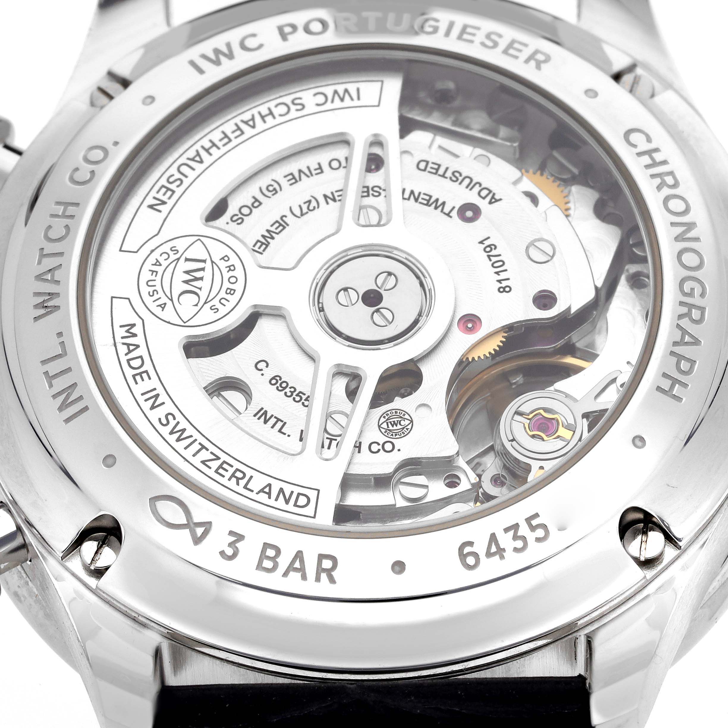 The image shows the back of the IWC Portugieser Chronograph, highlighting its movement and engravings.