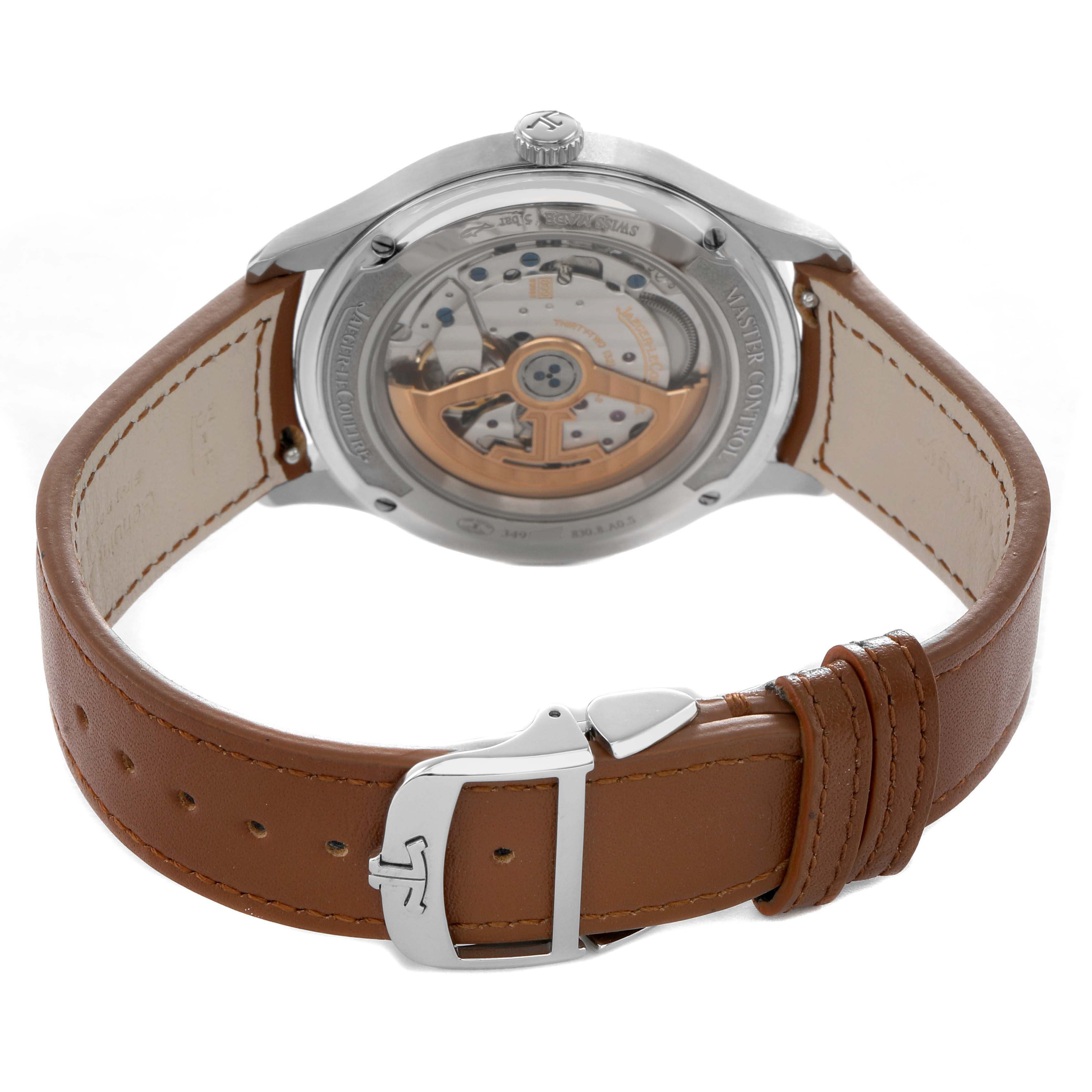 The Jaeger LeCoultre Master Q4018420 Men's Stainless Steel Silver Dial model watch is shown from the back, displaying its movement and brown leather strap with a deployment clasp.