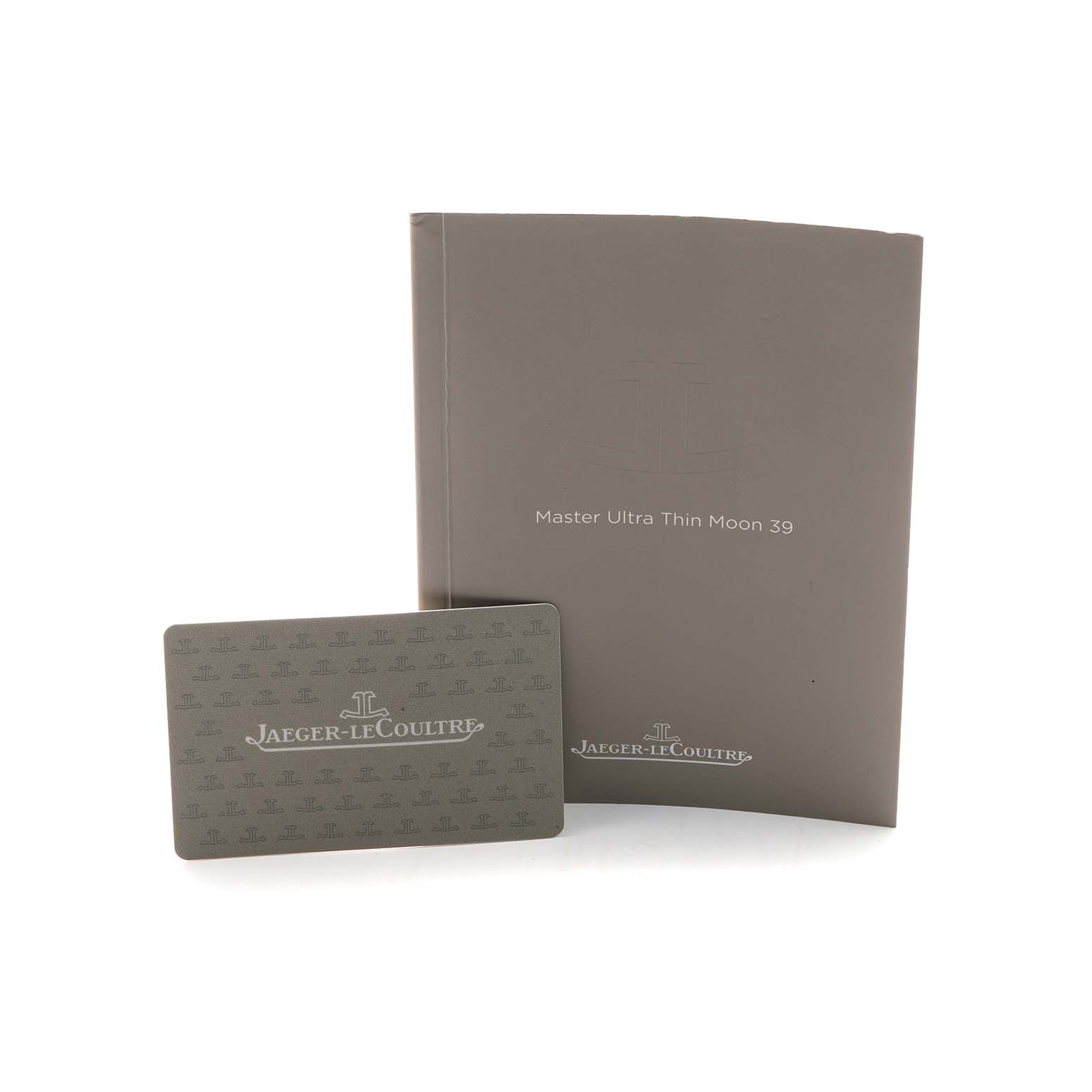 The image shows a manual and a warranty card for the Jaeger LeCoultre Master Q1368470 Men's Stainless Steel Black Dial Ultra Thin Moon 39, viewed from the front.