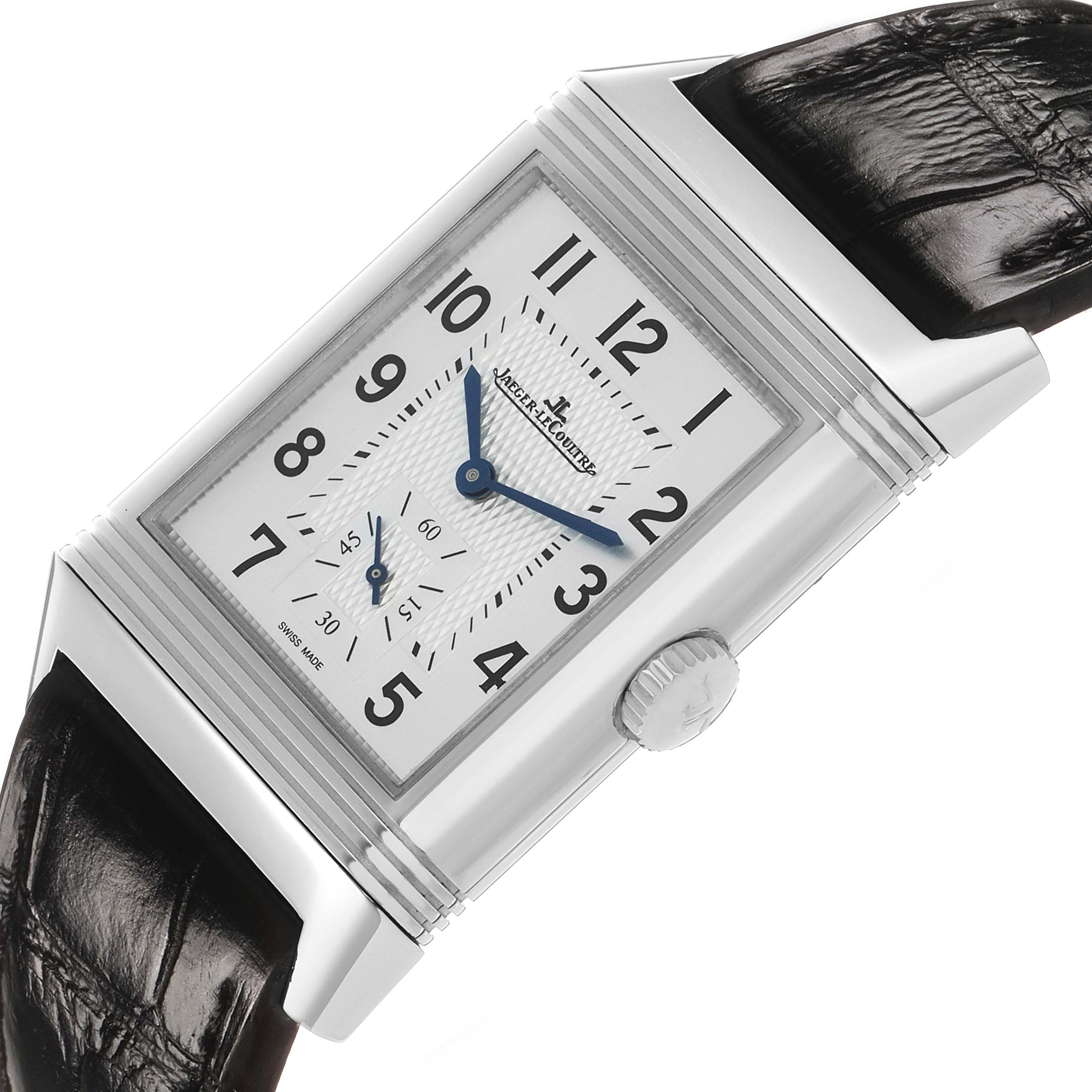 The Jaeger-LeCoultre Reverso watch is shown at an angle highlighting the front face, crown, and leather strap.