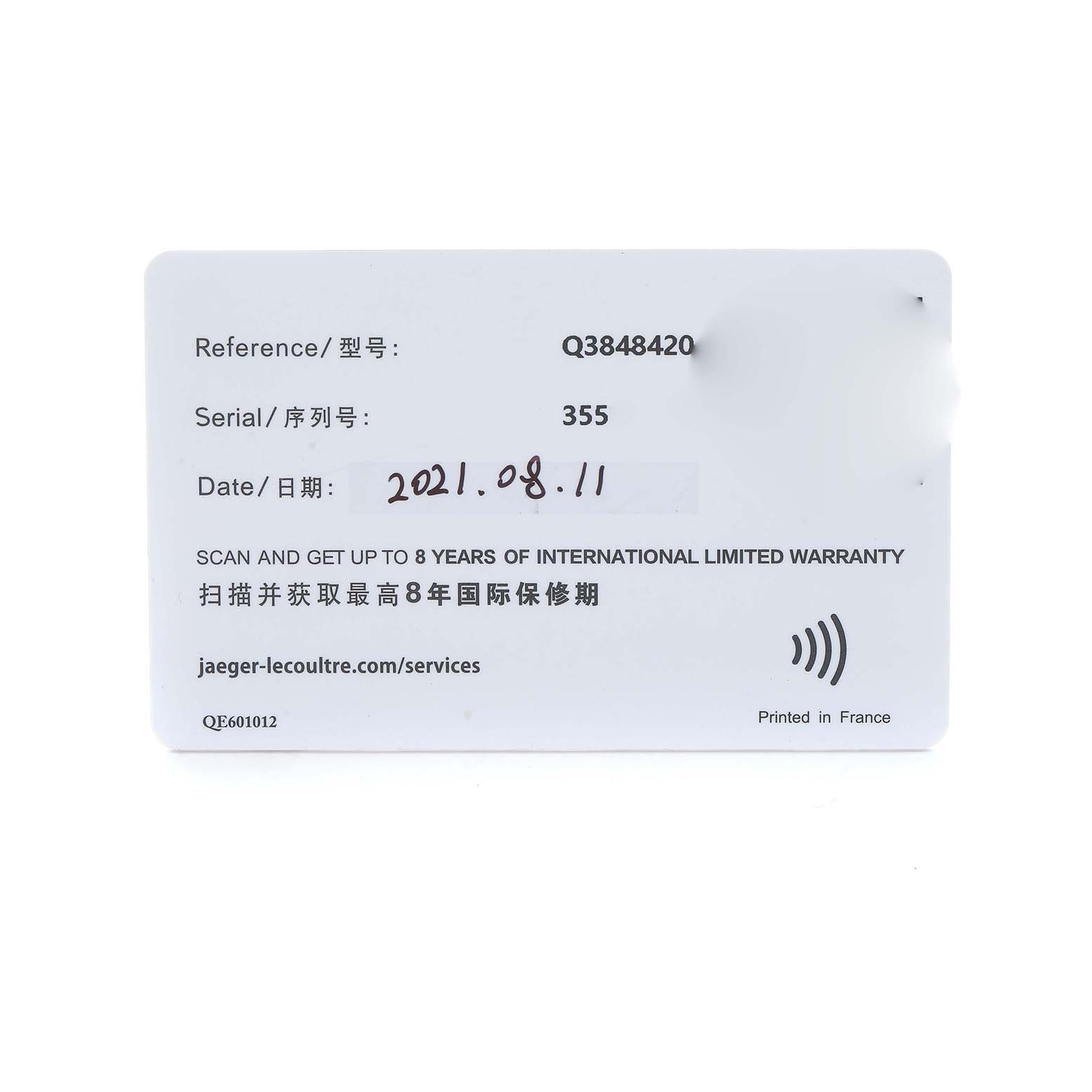 The image shows a warranty card for the Jaeger-LeCoultre Reverso model, featuring reference, serial number, and date details.