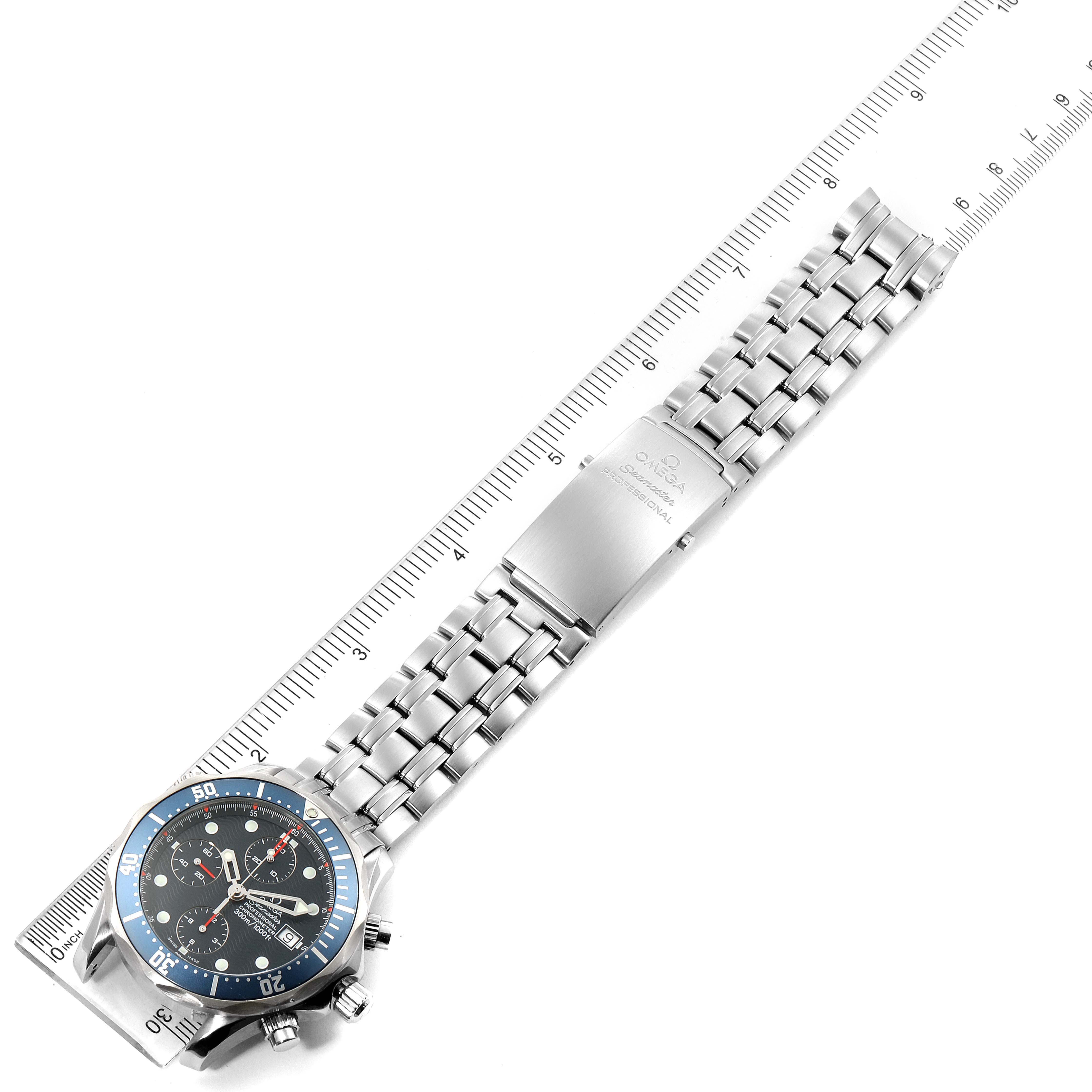 The image shows an Omega Seamaster 2599.80.00 Men
s Stainless Steel Blue Dial 2599.80.00 Men
s Stainless Steel Blue Dial watch flat laid, including the face, bracelet, clasp, and a ruler for scale.