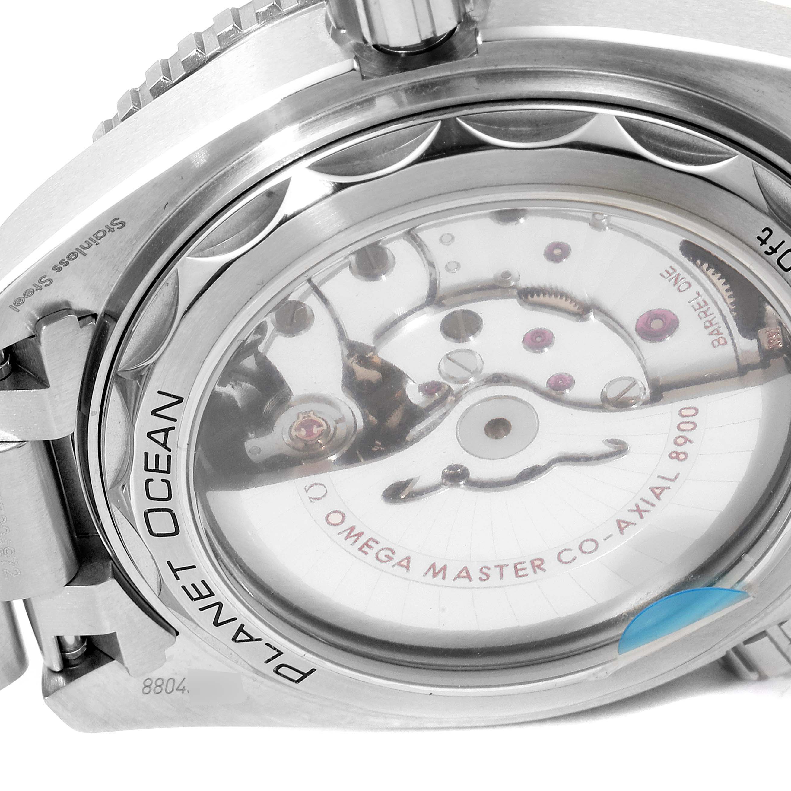 The image shows the back case of the Omega Planet Ocean 215.30.44.21.01.001 Men
s Stainless Steel Black Dial 215.30.44.21.01.001 Men
s Stainless Steel Black Dial watch, highlighting its inner mechanical parts and the transparent case back.