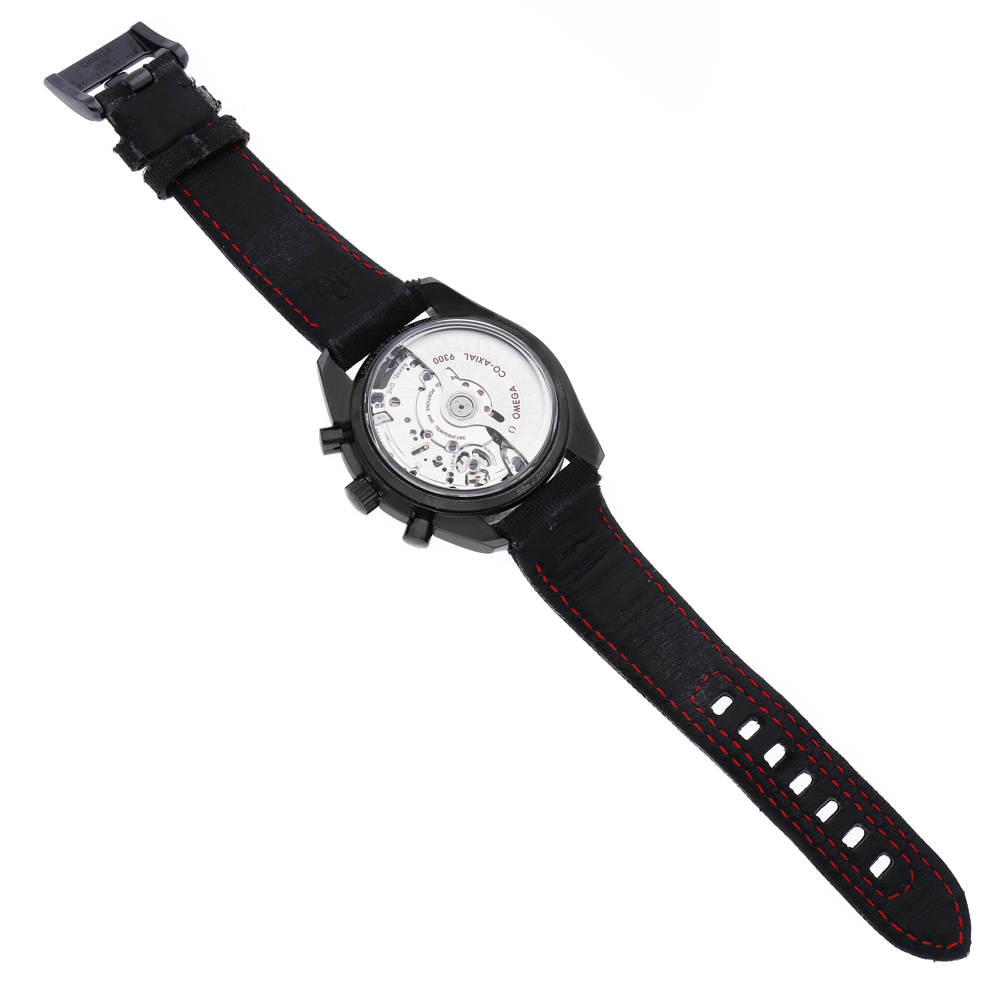 The Omega Speedmaster 311.92.44.51.01.003 Men's Ceramic Black Dial watch is shown from the back, displaying its movement and strap with red stitching.