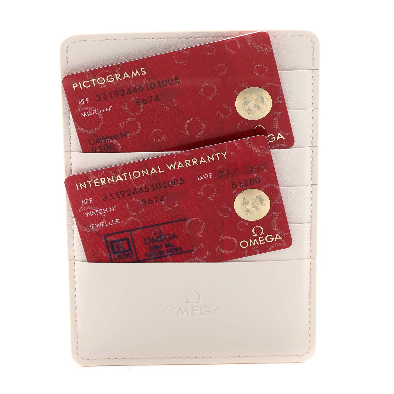 The image shows warranty and pictogram cards in a white Omega cardholder for the Omega Speedmaster 311.92.44.51.01.005 Men's Ceramic Black Dial model.