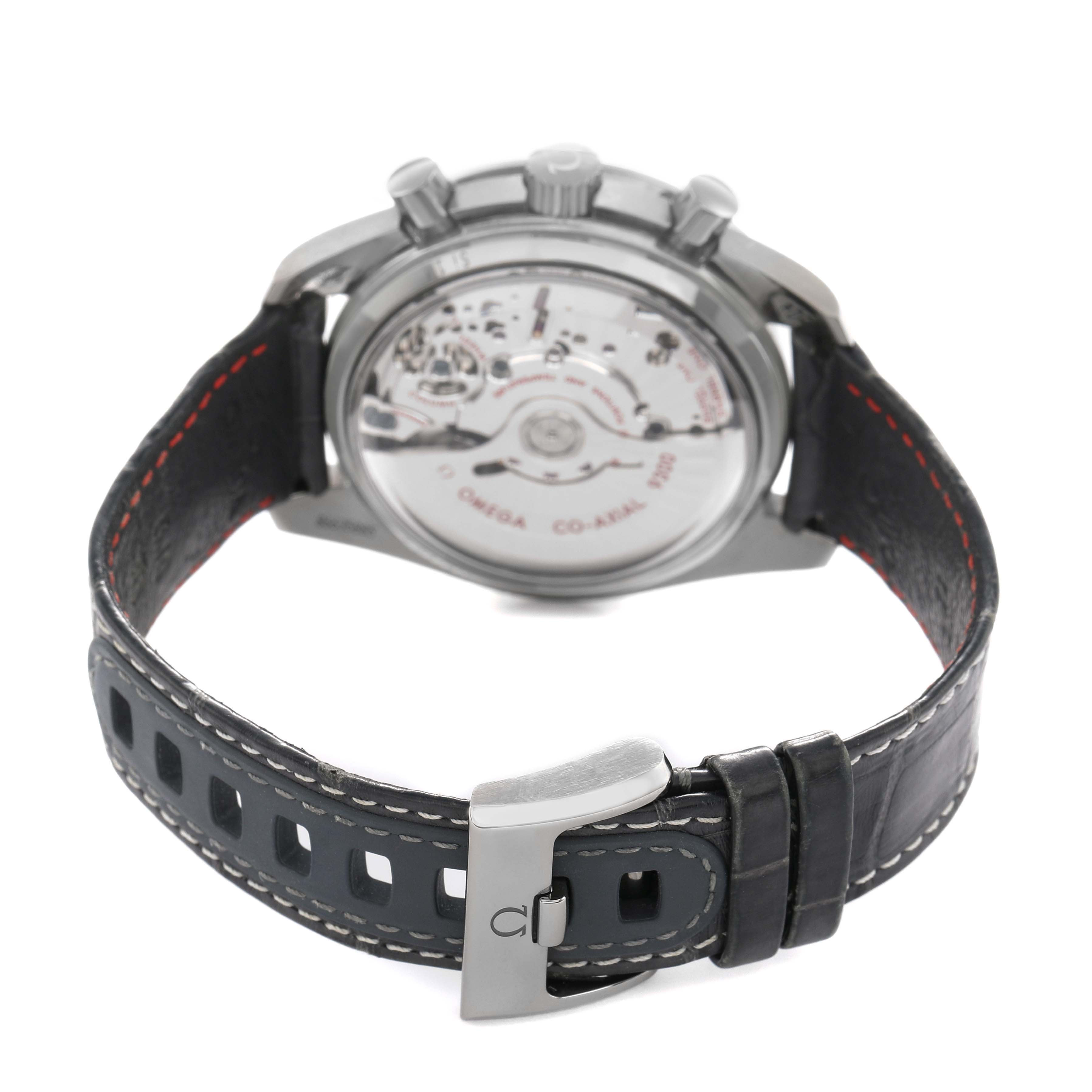 The Omega Speedmaster 311.93.44.51.99.001 Men's Ceramic Grey Dial watch is shown from the back, highlighting the movement and leather strap with deployant clasp.