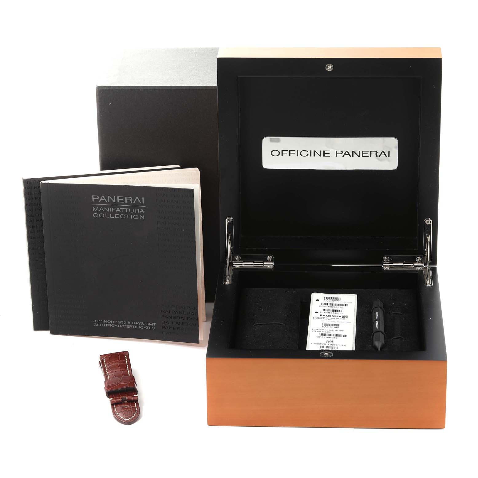 The image shows the packaging, manuals, and an extra strap for a Luminor model by Panerai.