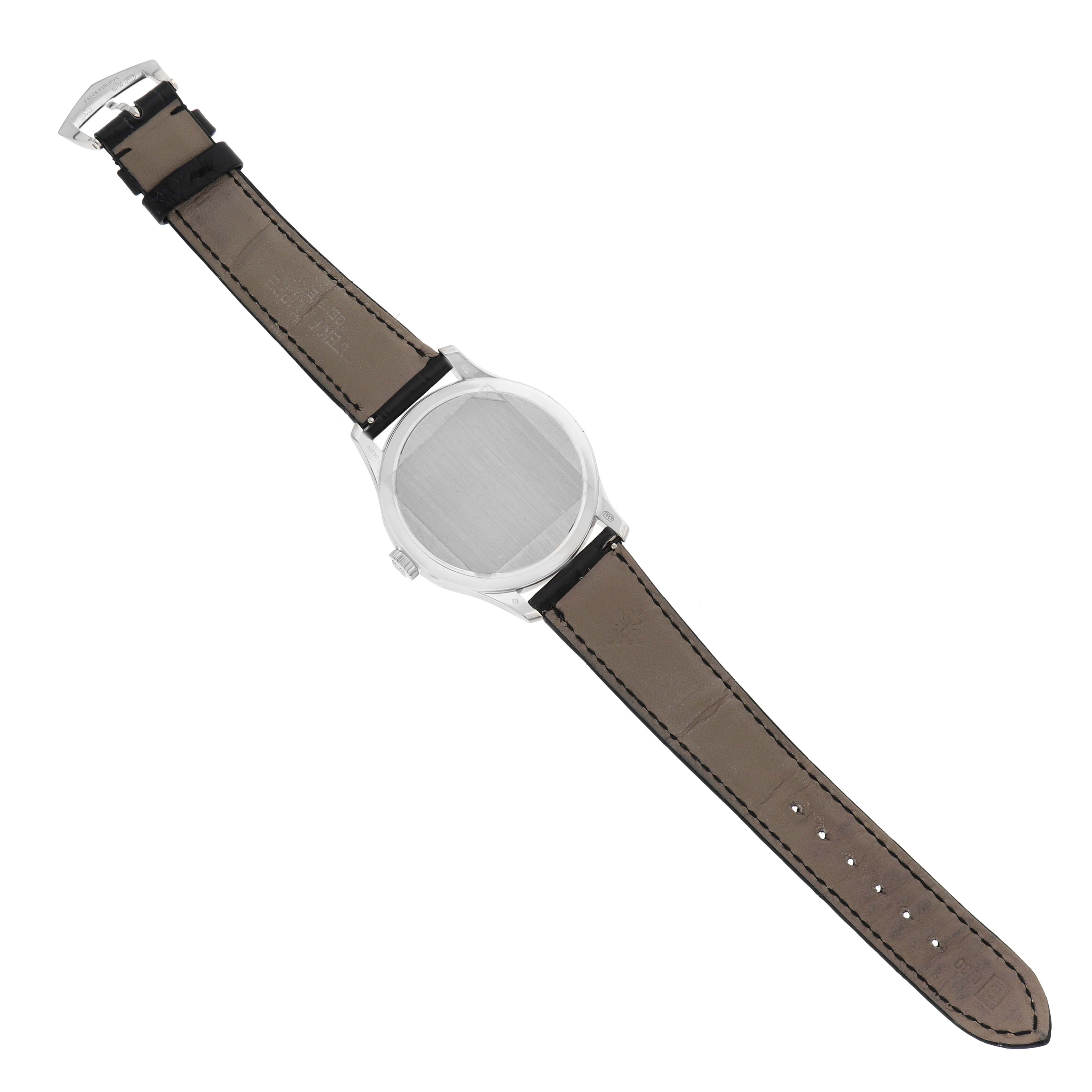 The Patek Philippe Calatrava 5227G Men's White Gold Beige Dial is shown from the back, revealing the strap, buckle, and closed case back.