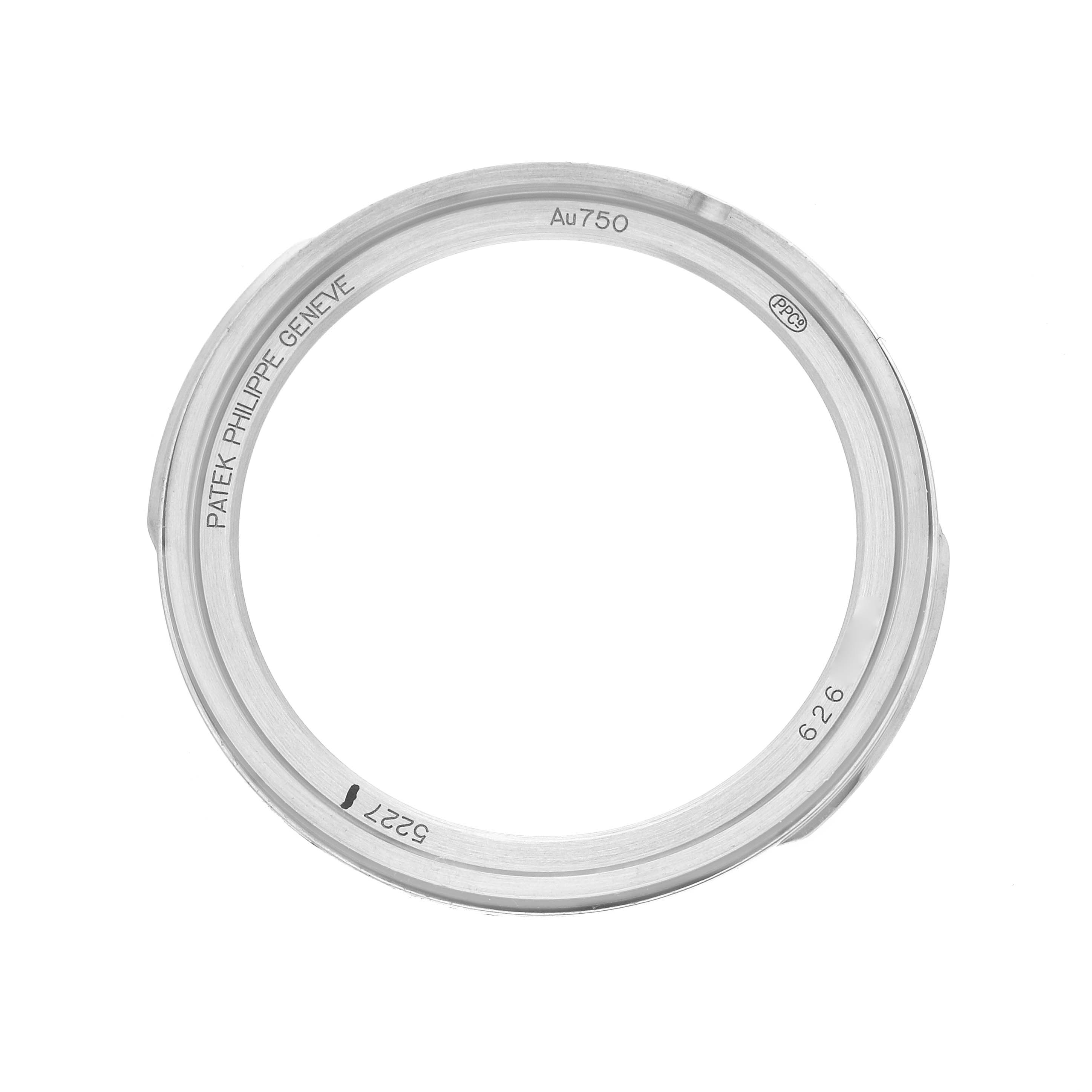 The image shows a Patek Philippe Calatrava 5227G Men's White Gold Beige Dial watch bezel from a top-down angle, displaying engravings and markings.