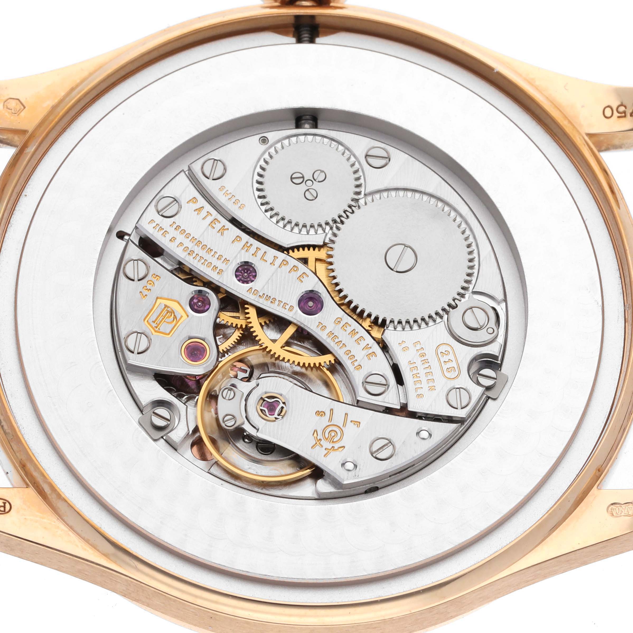 The image shows the back view of a Patek Philippe Calatrava 5196R-001 Men
s Rose Gold Silver Dial 5196R-001 Men
s Rose Gold Silver Dial watch, highlighting its intricate movement and mechanics.