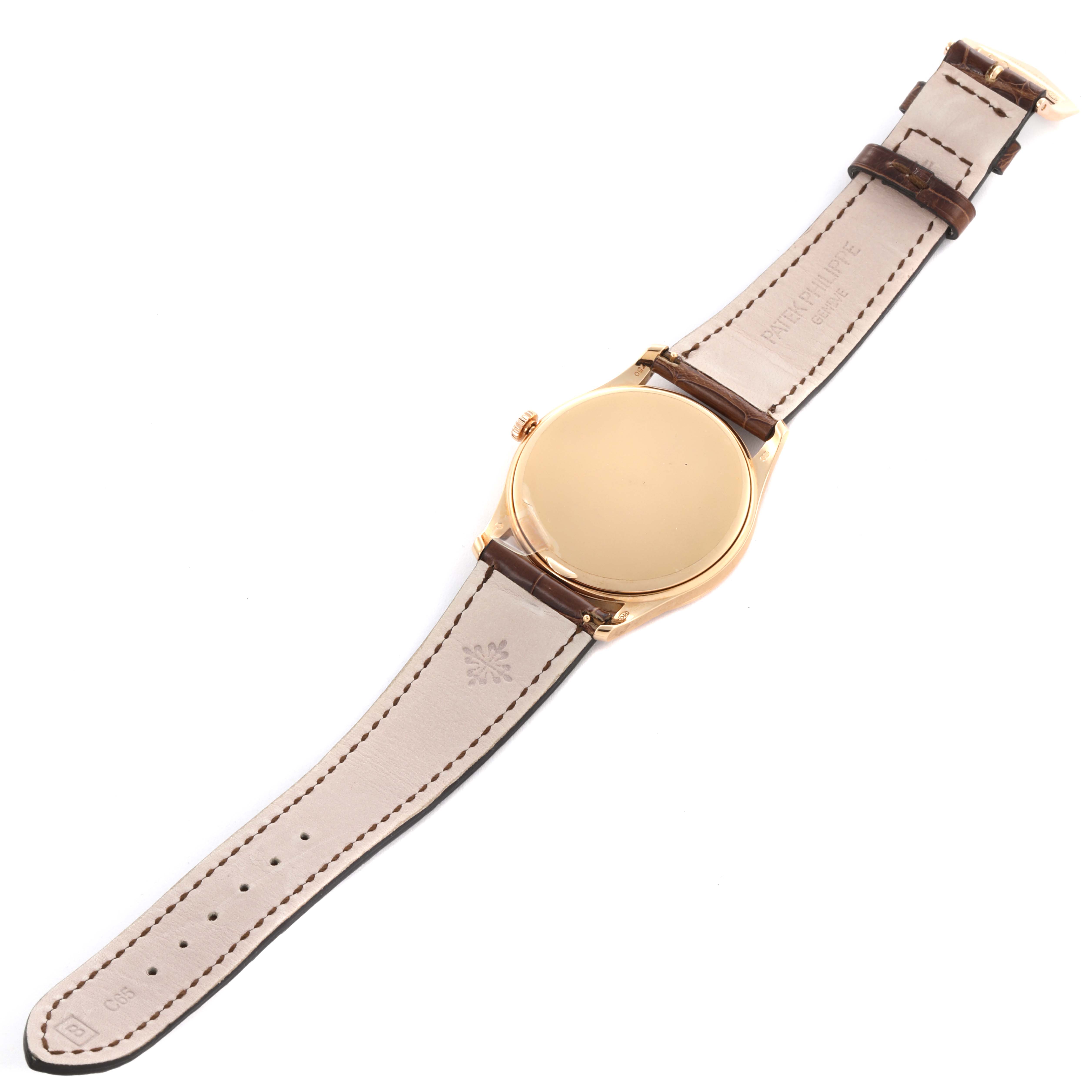 The image shows the back case and leather strap of a Patek Philippe Calatrava 5196R-001 Men
s Rose Gold Silver Dial 5196R-001 Men
s Rose Gold Silver Dial watch from a top view angle.
