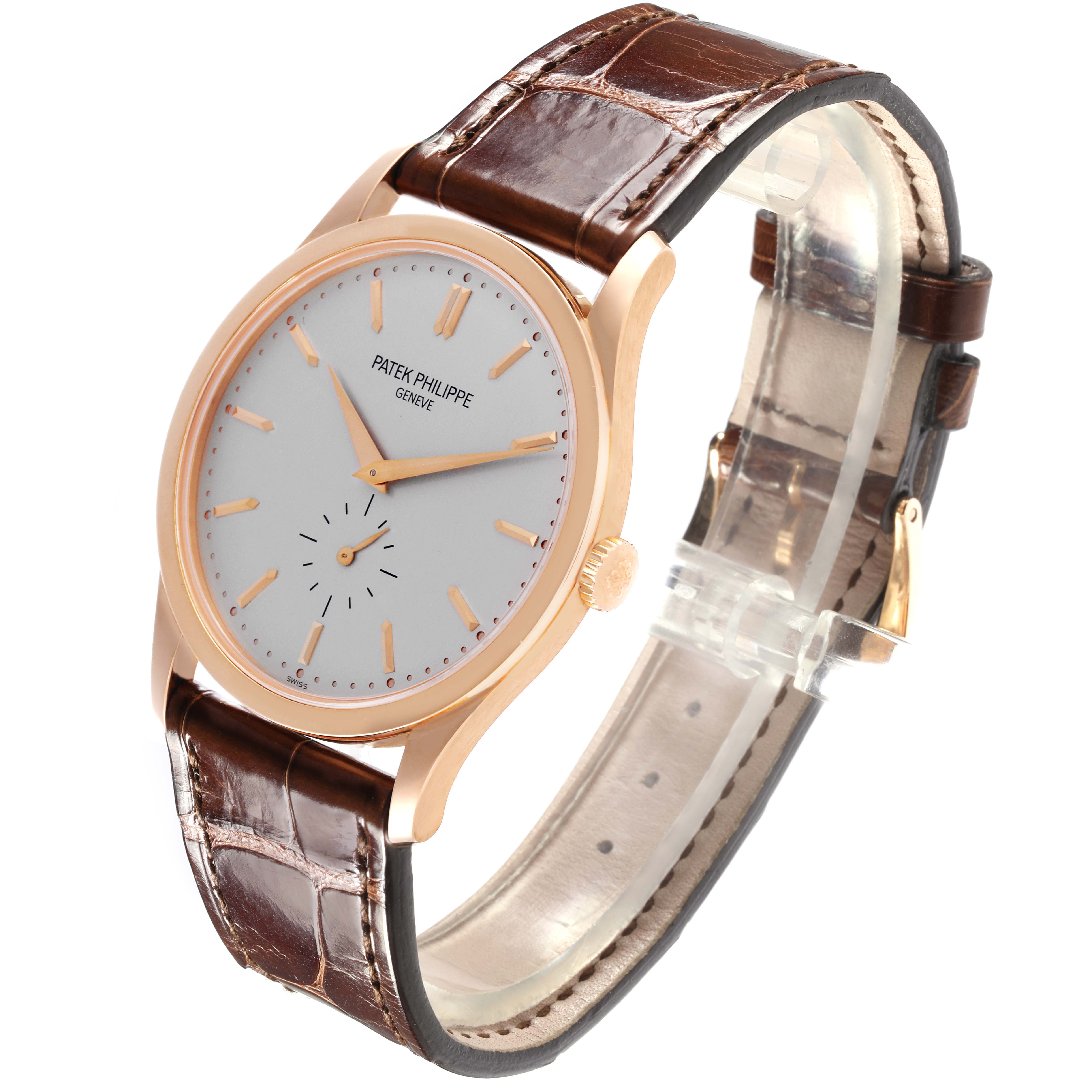 The Patek Philippe Calatrava 5196R-001 Men
s Rose Gold Silver Dial 5196R-001 Men
s Rose Gold Silver Dial watch is shown at an angled side view, displaying the face, case, strap, and crown.