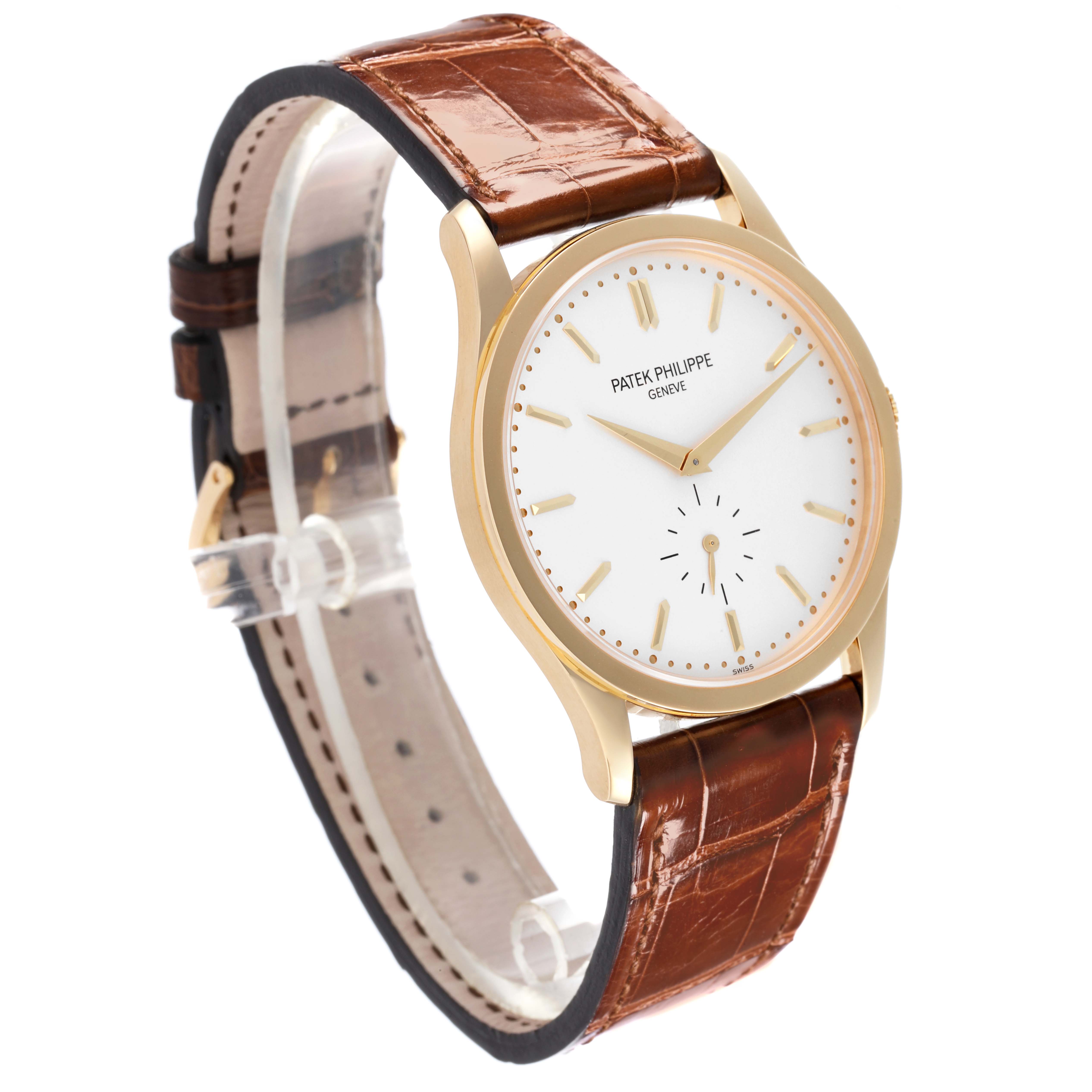 The Patek Philippe Calatrava 5196J Men's Yellow Gold Silver Dial 5196J Men's Yellow Gold Silver Dial watch is angled to show the face, case, and brown leather strap.