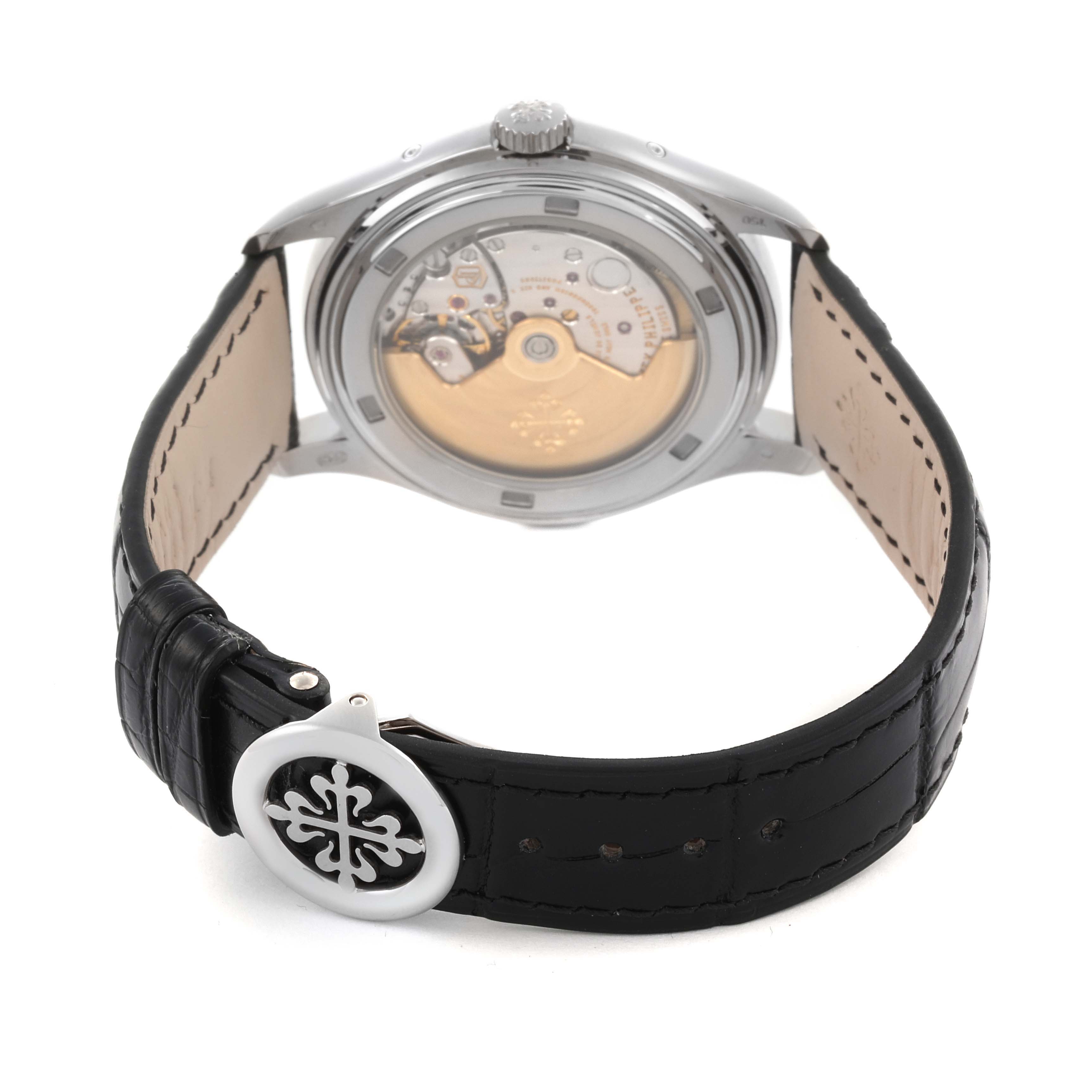The Patek Philippe Complications 5146G Men
s White Gold White Dial 5146G Men
s White Gold White Dial model is shown from the back, highlighting its movement, crown, and black leather strap.