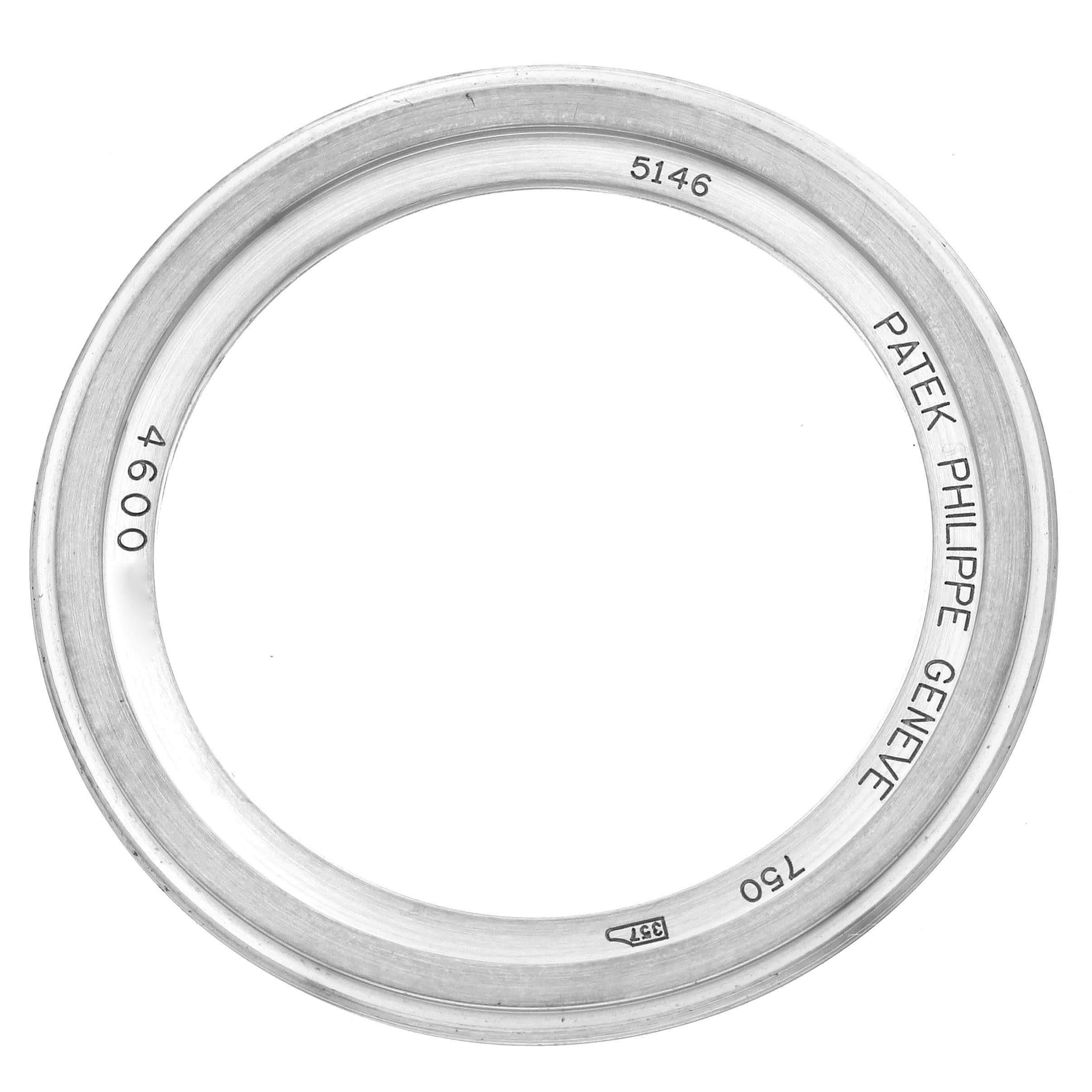 The image shows a bezel from a Patek Philippe Complications 5146G Men
s White Gold White Dial 5146G Men
s White Gold White Dial watch, viewed from above.