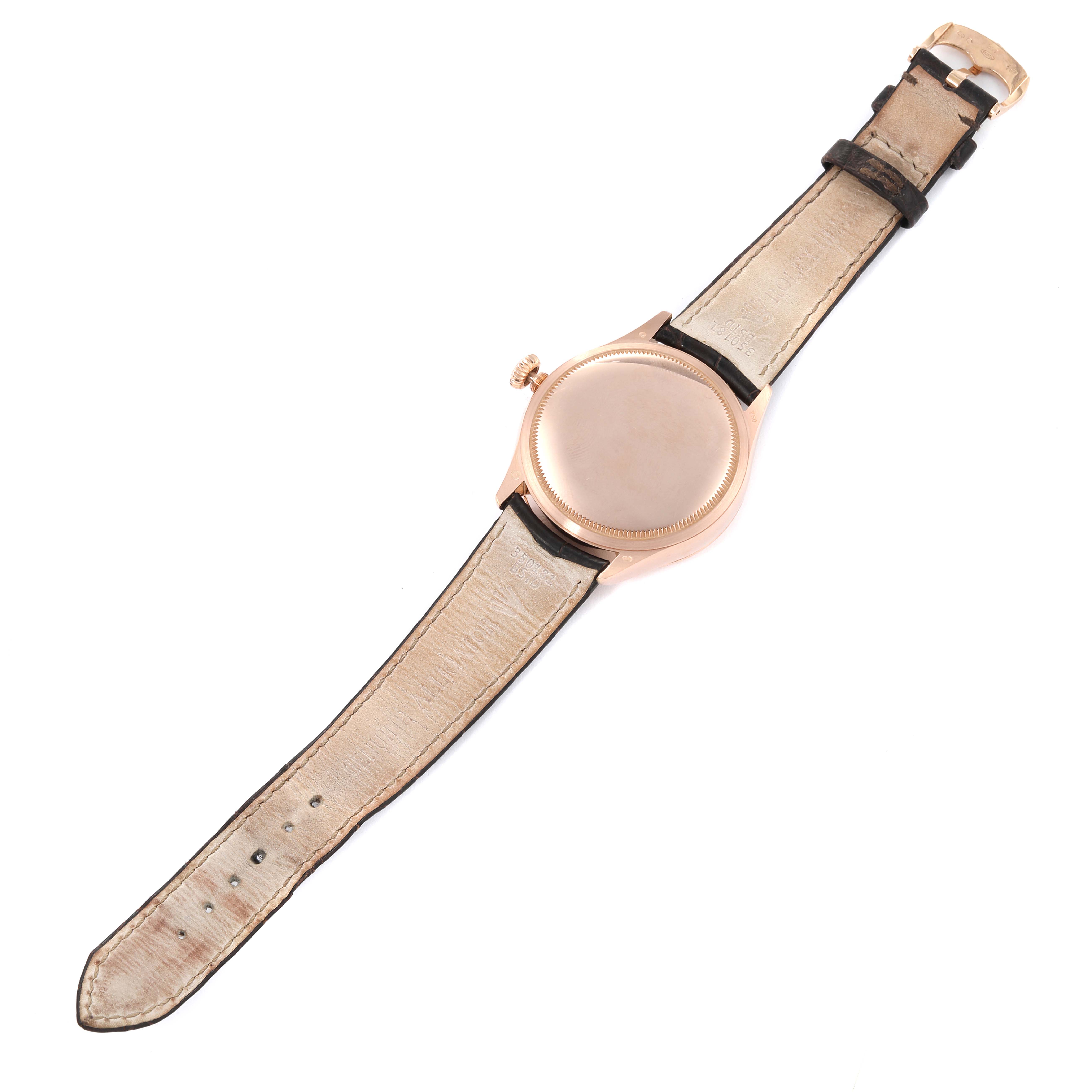 The Rolex Cellini 50515 Men's Rose Gold Black Dial 50515 Men's Rose Gold Black Dial watch is shown from the back with a full view of the strap and the case back.