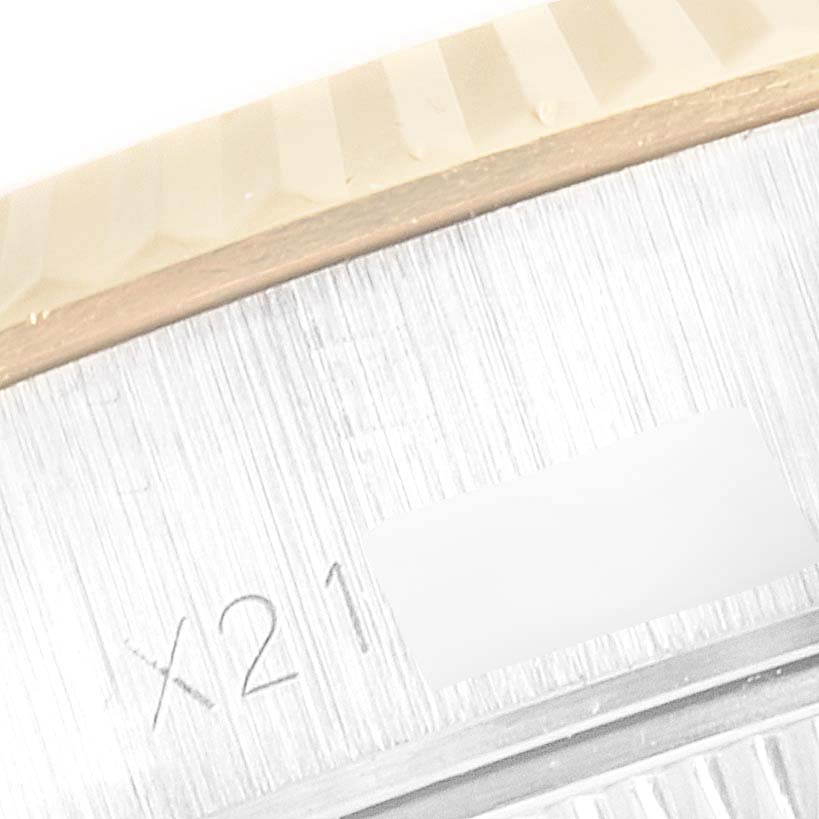 The image shows a close-up view of the fluted bezel and part of the case of a Rolex Datejust 69173 Women
s Steel and Gold (two tone) Champagne Dial 69173 Women
s Steel and Gold (two tone) Champagne Dial watch, with a partial serial number visible.