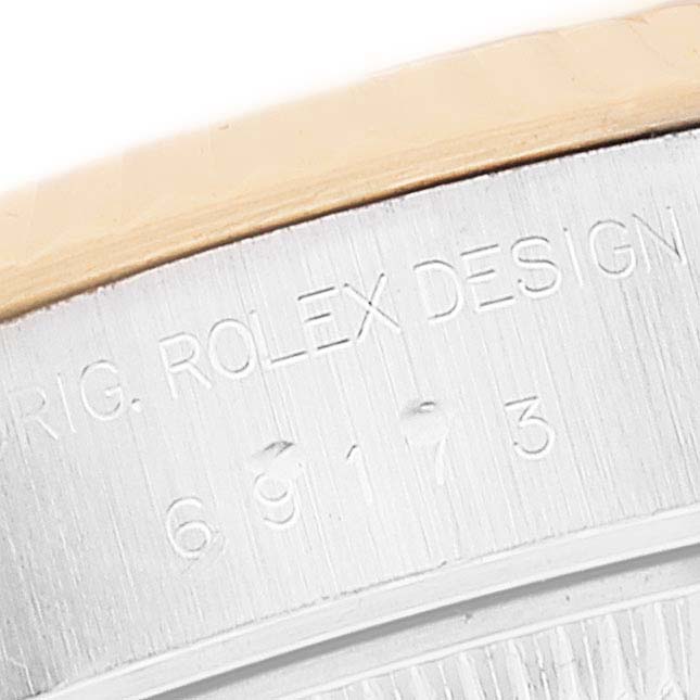 This image shows the engraved side of a Rolex Datejust 69173 Women's Steel and Gold (two tone) Silver Dial 69173 Women's Steel and Gold (two tone) Silver Dial watch case with the model number visible.