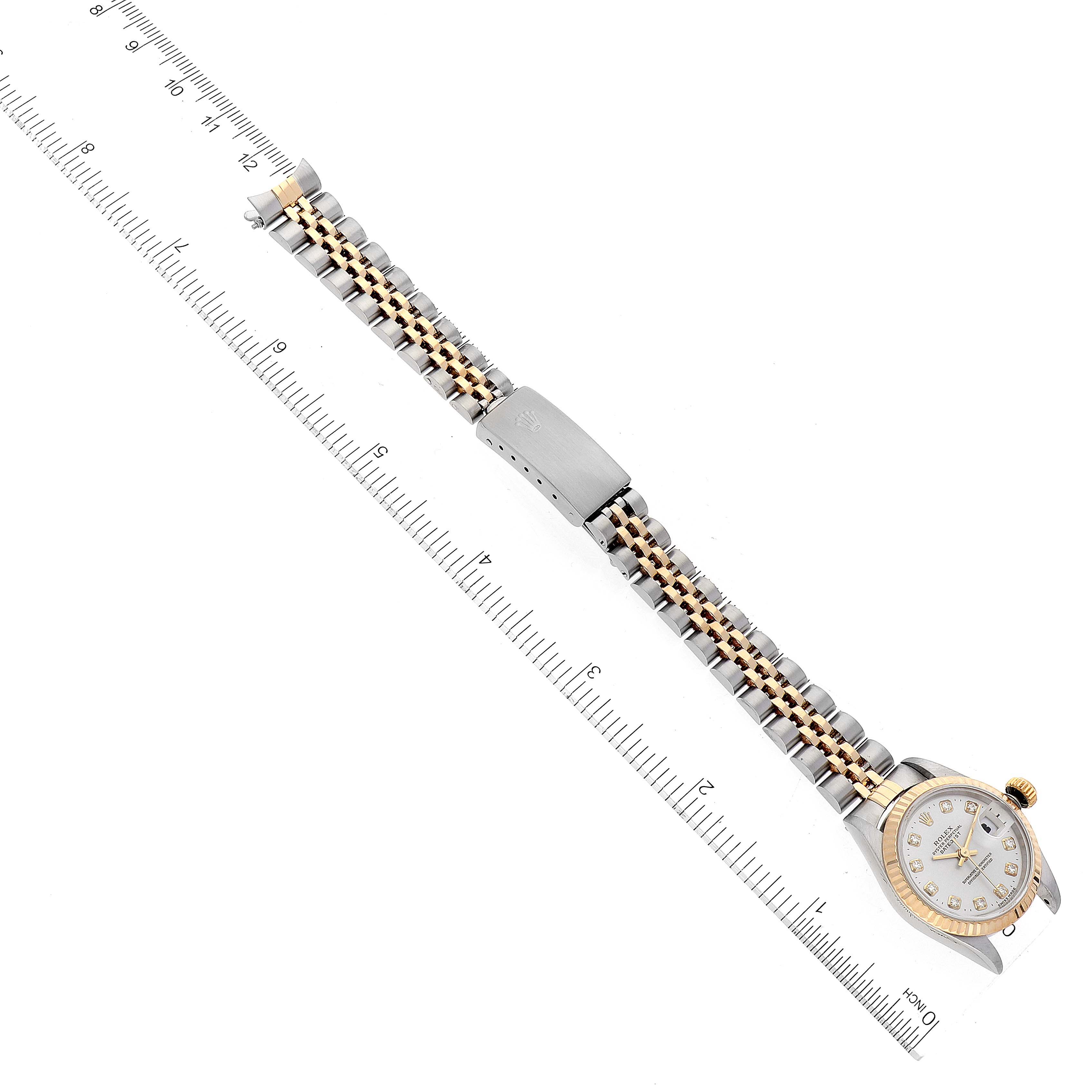 The image shows a Rolex Datejust 69173 Women's Steel and Gold (two tone) Silver Dial 69173 Women's Steel and Gold (two tone) Silver Dial watch laid flat with rulers on each side, highlighting the watch strap and face.