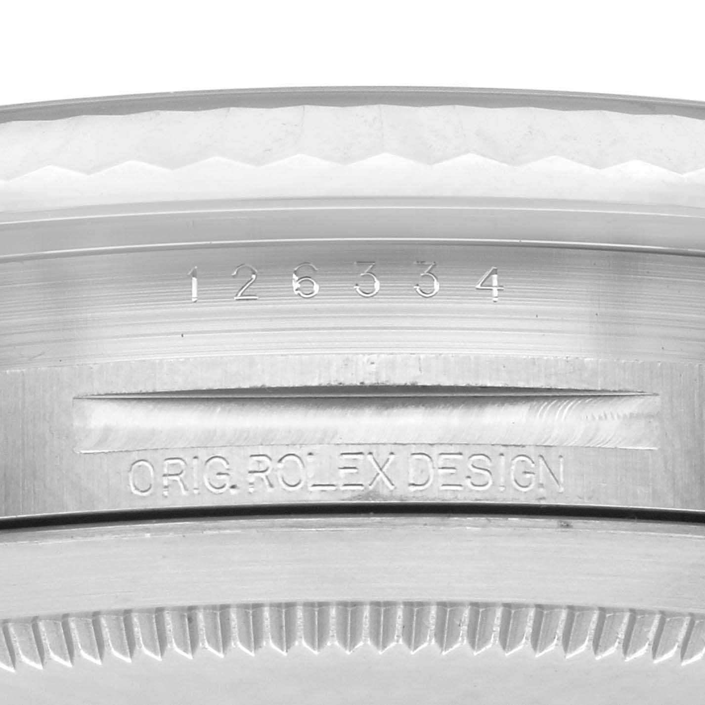 The image shows a close-up of the side of a Rolex Datejust 41 126334 Men's Stainless Steel Blue Dial 126334 Men's Stainless Steel Blue Dial, focusing on the model number and "ORIG ROLEX DESIGN" engraving.