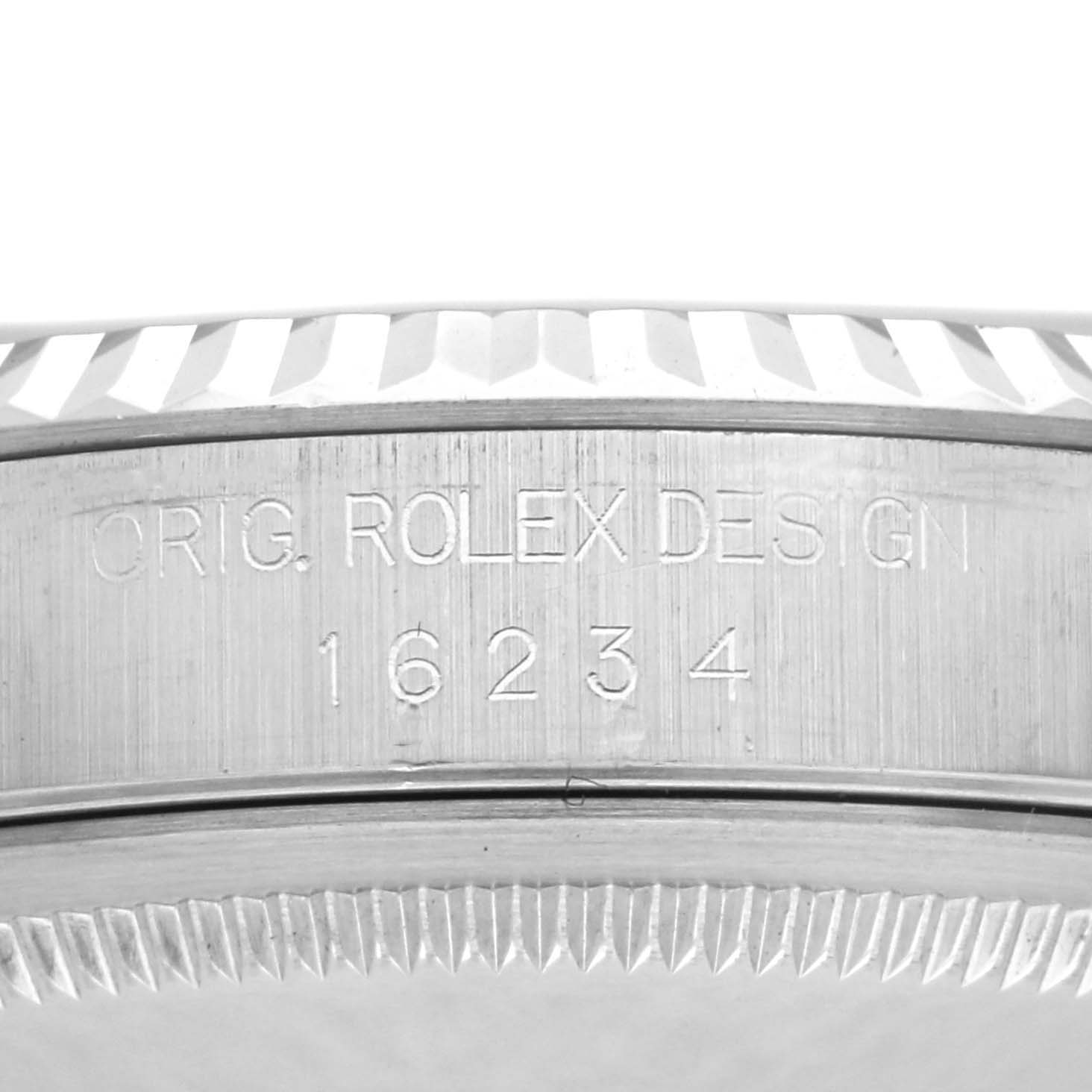 The image shows a close-up of the engraved bezel and serial number on a Rolex Datejust 16234 Men
s Stainless Steel Black Dial 16234 Men
s Stainless Steel Black Dial watch.
