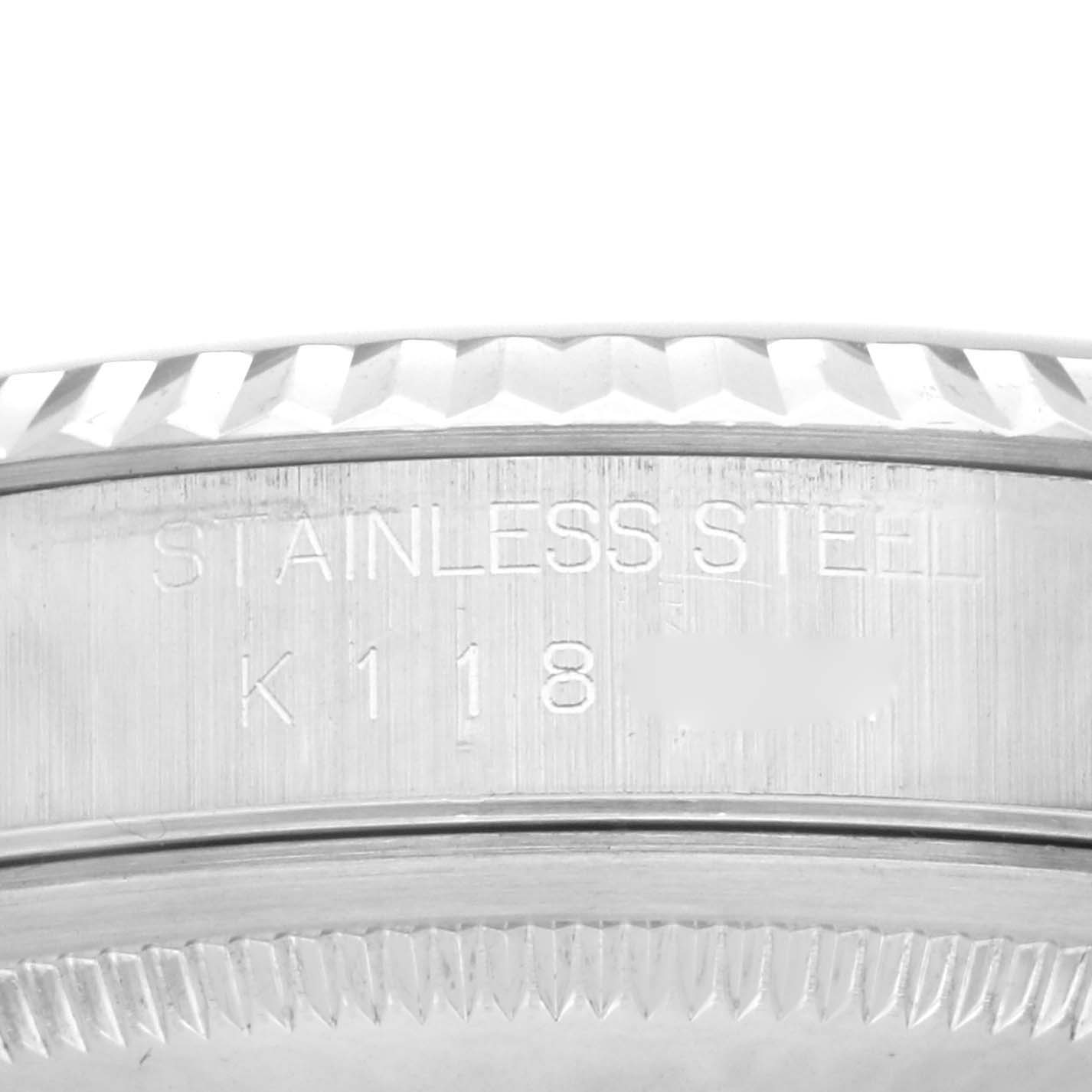 The image shows a close-up of the bezel and edge of the case with engravings on the Rolex Datejust 16234 Men
s Stainless Steel Black Dial 16234 Men
s Stainless Steel Black Dial watch.