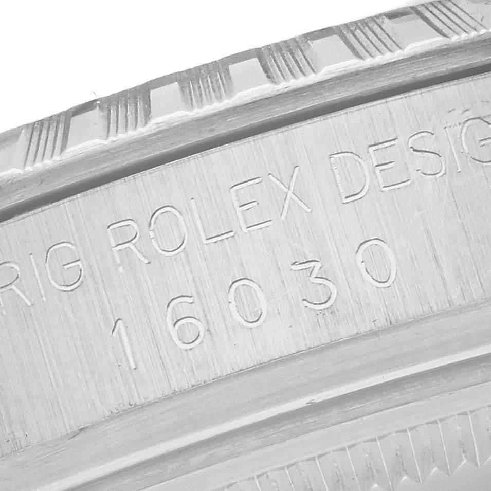 The image shows an engraved model number and design details on the edge of a Rolex Vintage Collection 16030 Men's Stainless Steel Silver Dial 16030 Men's Stainless Steel Silver Dial watch case.