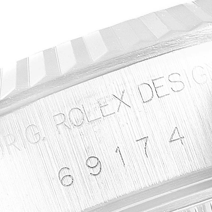 This is a close-up image showing the engraved case side of the Rolex Datejust 69174 Women's Stainless Steel Pink Dial 69174 Women's Stainless Steel Pink Dial model 69174.