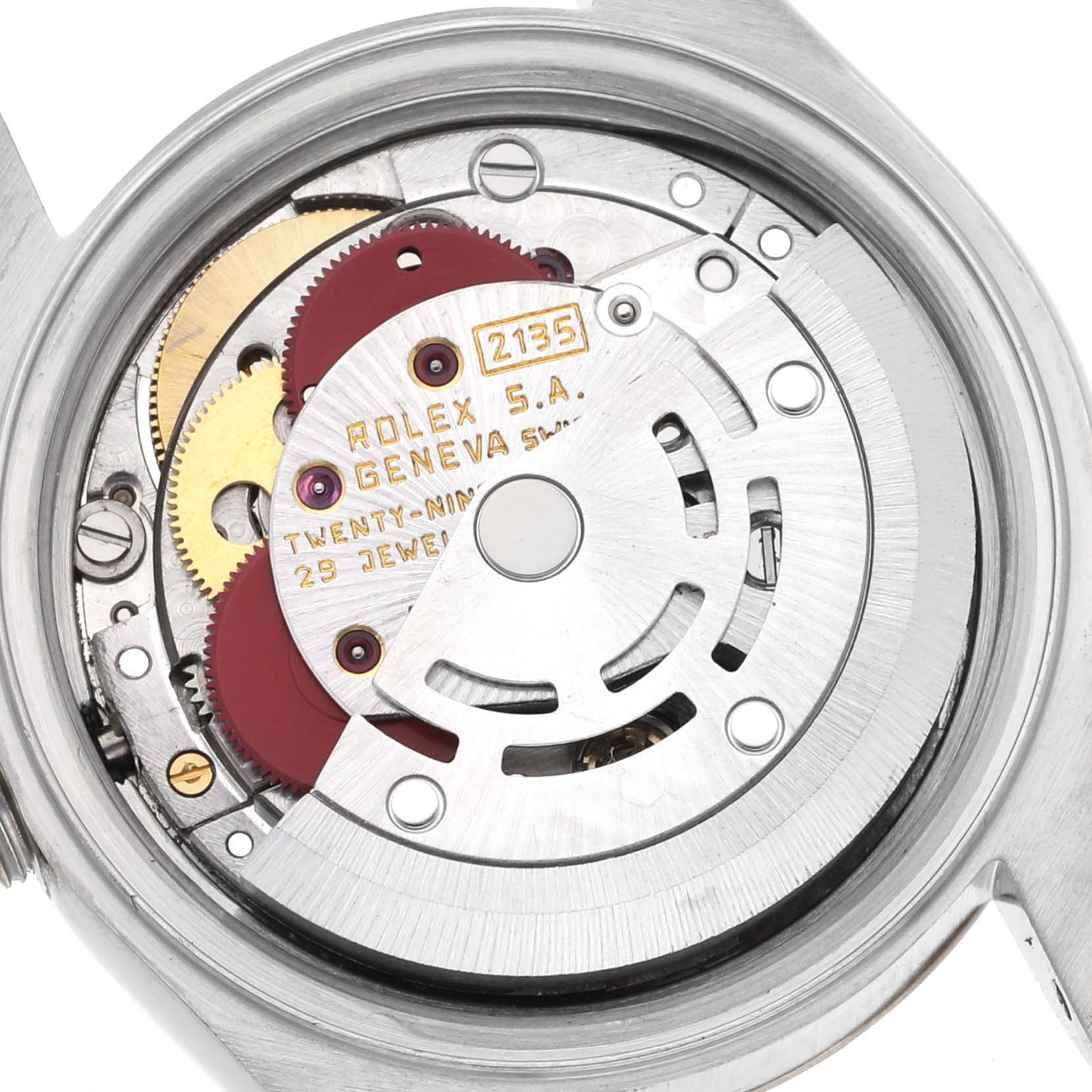 The image shows the inner mechanism of a Rolex Datejust 69173 Women's Steel and Gold (two tone) Silver Dial 69173 Women's Steel and Gold (two tone) Silver Dial, highlighting gears and the rotor of the watch movement.