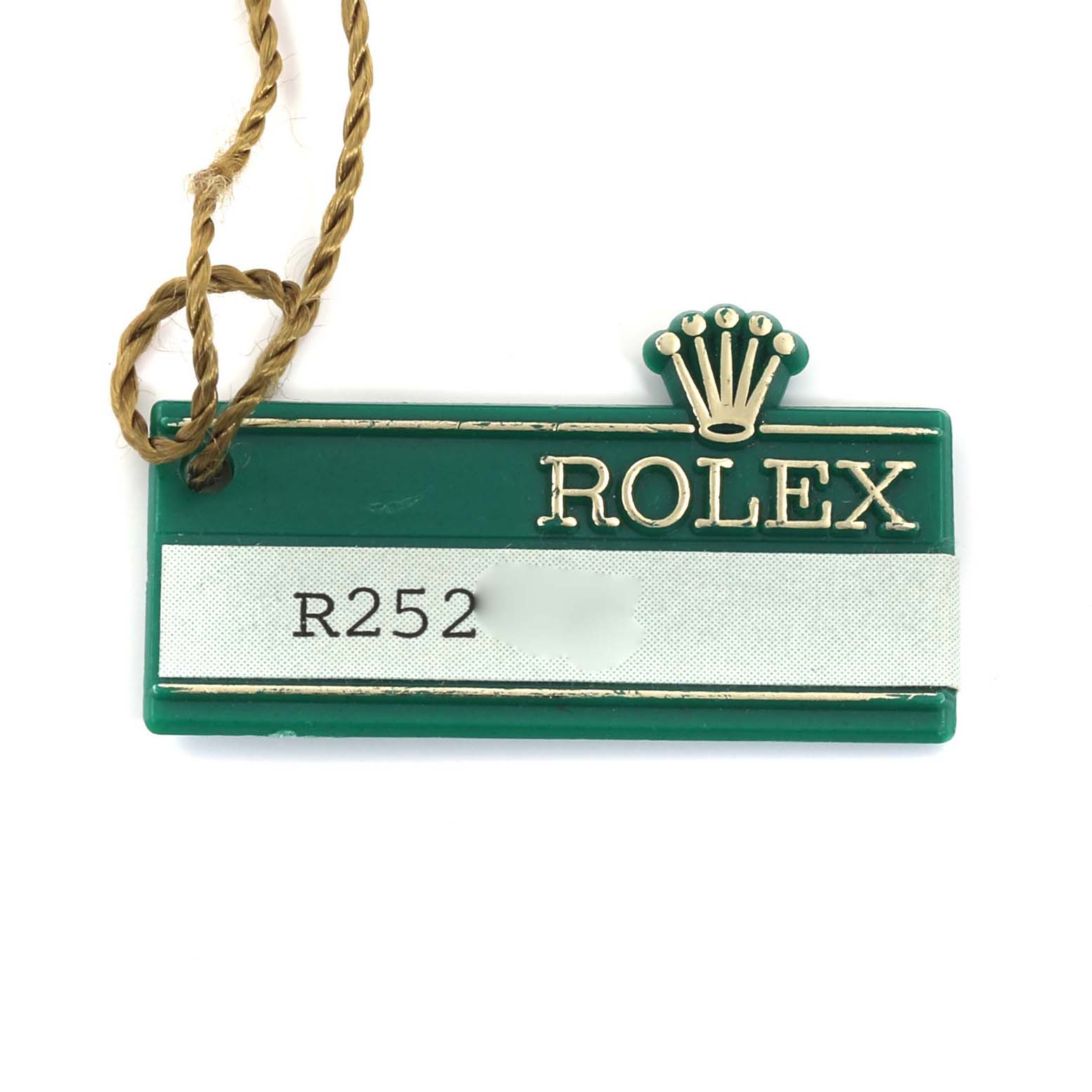 The image shows a green Rolex Datejust 69173 Women's Steel and Gold (two tone) Silver Dial 69173 Women's Steel and Gold (two tone) Silver Dial model tag with the brand logo and a serial number.