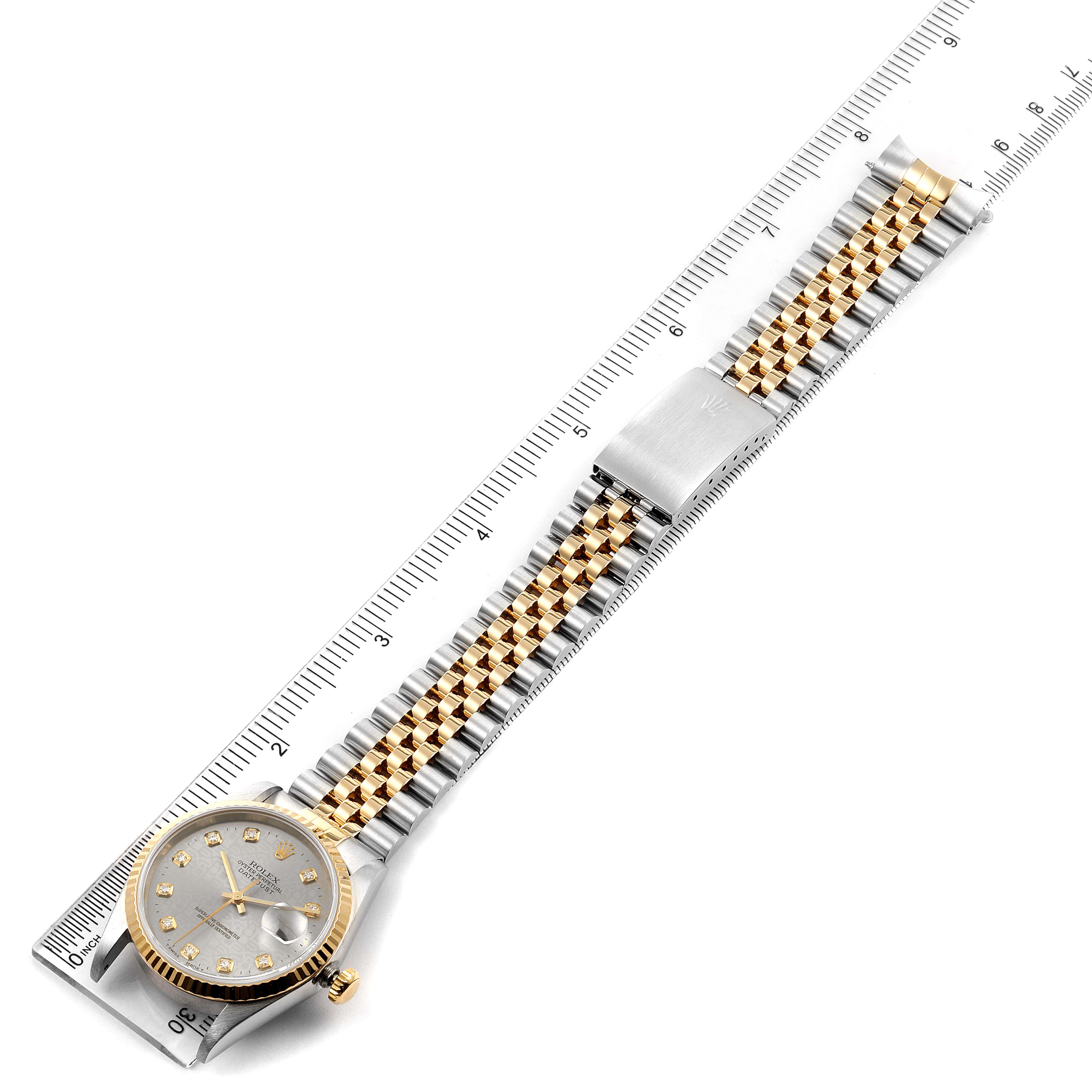 The image shows a Rolex Datejust 16233 Men's Steel and Gold (two tone) Silver Dial 16233 Men's Steel and Gold (two tone) Silver Dial watch laid flat with its dial, bezel, bracelet, and clasp visible, alongside a ruler for scale.