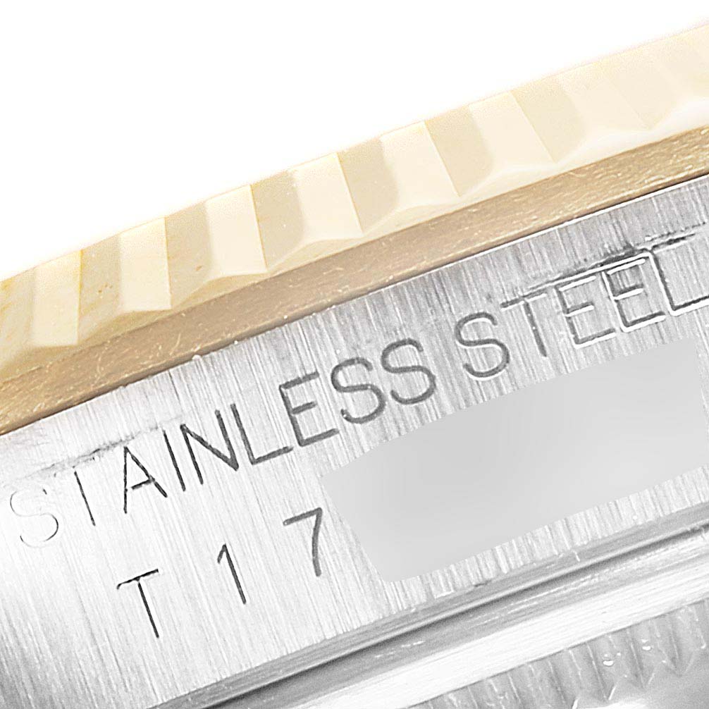 This is a close-up of the side of a Rolex Datejust 16233 Men's Steel and Gold (two tone) Silver Dial 16233 Men's Steel and Gold (two tone) Silver Dial watch, showing the engraved "Stainless Steel" text and part of the bezel.