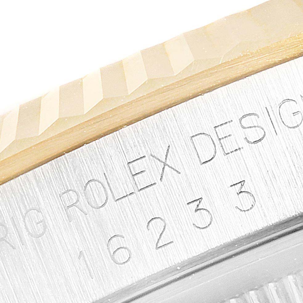 The image shows a close-up of the inscription on the bezel of a Rolex Datejust 16233 Men's Steel and Gold (two tone) Silver Dial 16233 Men's Steel and Gold (two tone) Silver Dial watch.