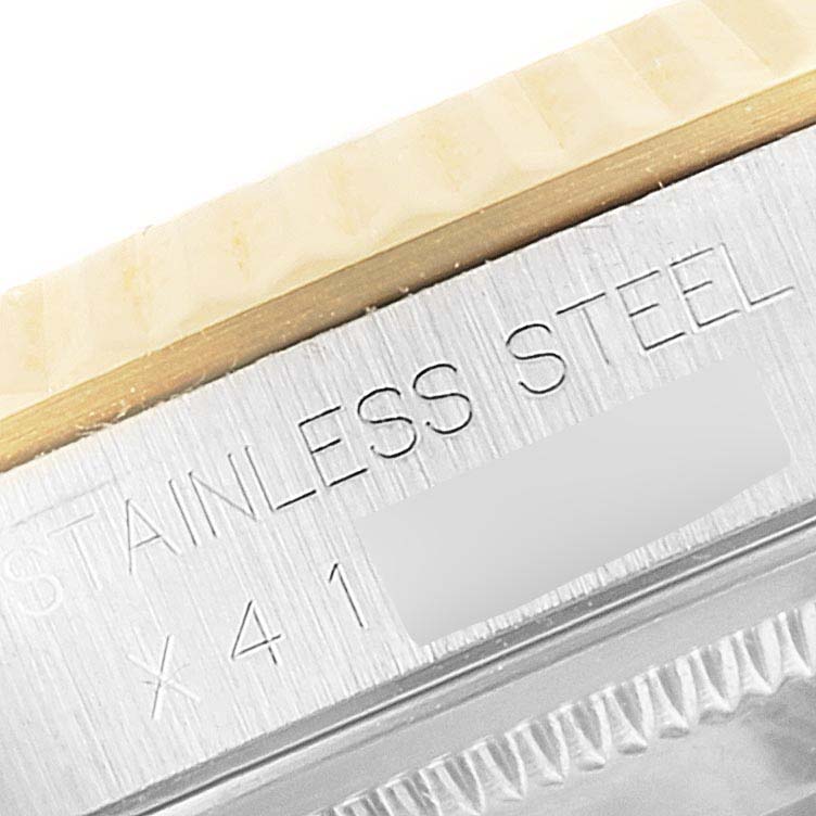 This image shows a close-up of the side inscription on the bezel and case of a Rolex Datejust 16233 Men's Steel and Gold (two tone) Champagne Dial 16233 Men's Steel and Gold (two tone) Champagne Dial watch.