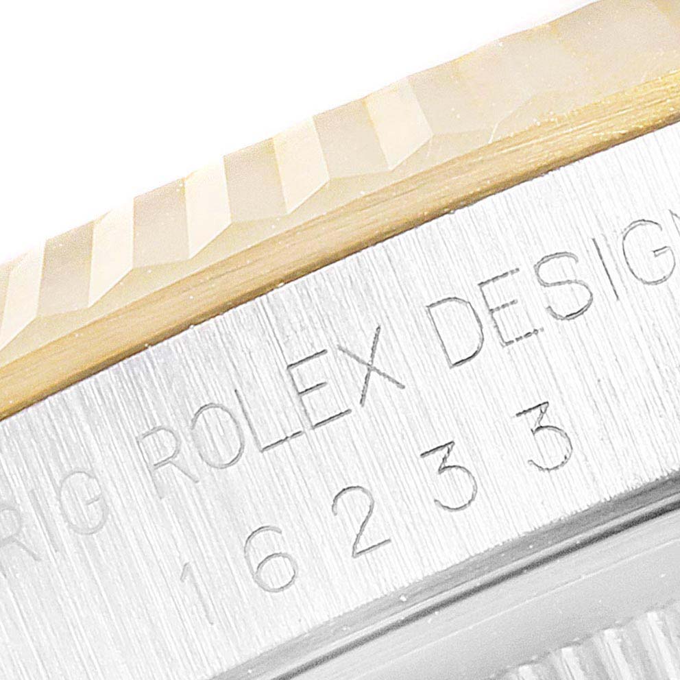 This is a close-up of the engraved side of a Rolex Datejust 16233 Men's Steel and Gold (two tone) Champagne Dial 16233 Men's Steel and Gold (two tone) Champagne Dial watch bezel and case, featuring model details.