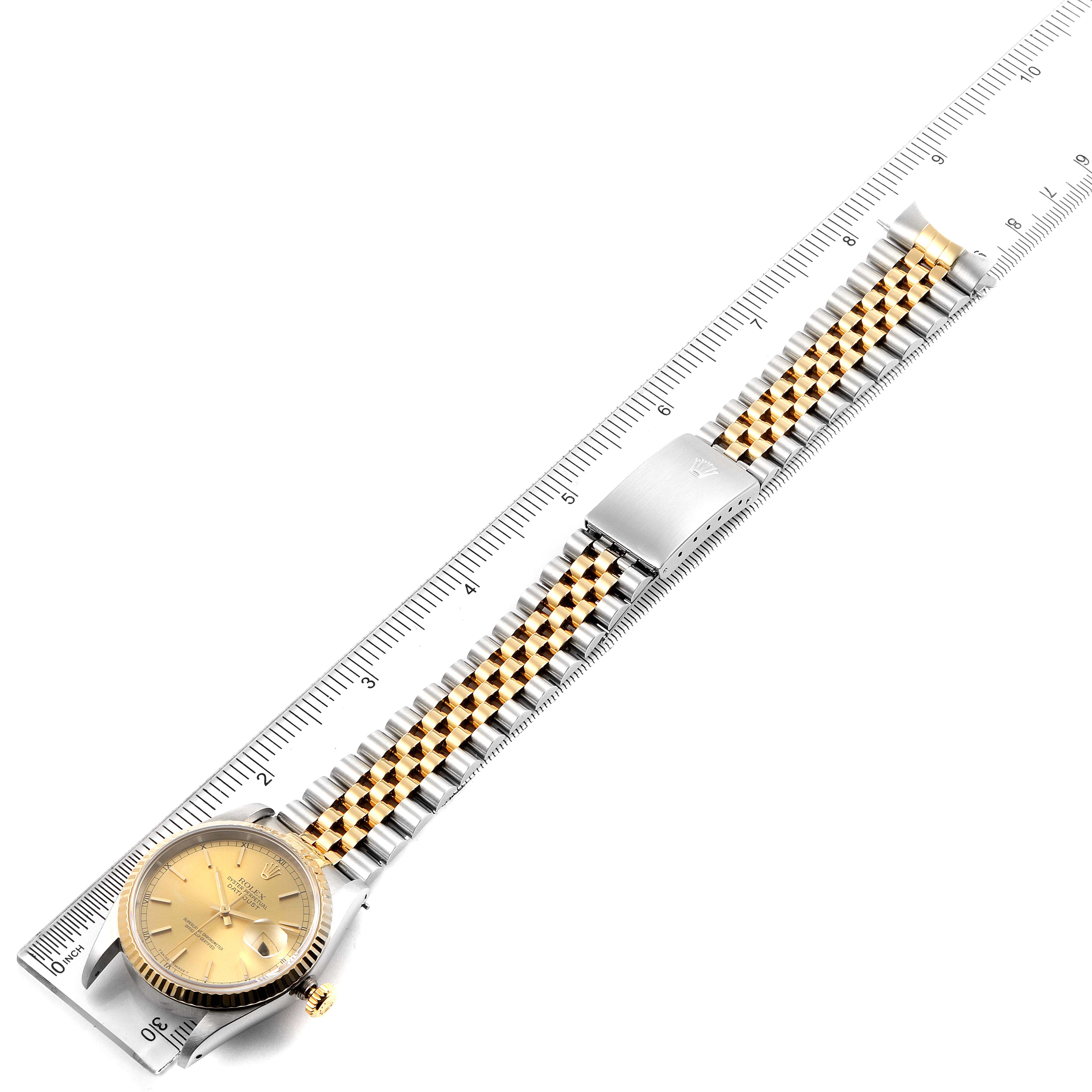 The image shows a Rolex Datejust 16233 Men's Steel and Gold (two tone) Champagne Dial 16233 Men's Steel and Gold (two tone) Champagne Dial watch laid flat on a ruler, displaying its face and metal bracelet.