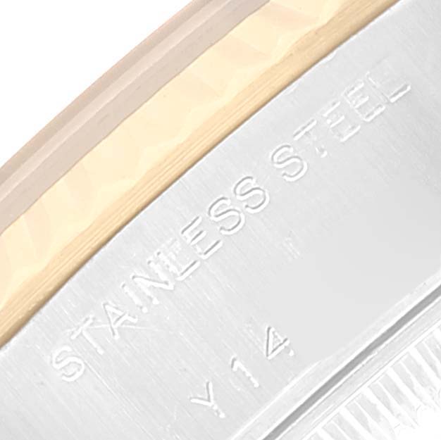 The image shows a close-up of the stainless steel part of the casing of a Rolex Datejust 79173 Women's Steel and Gold (two tone) Black Dial 79173 Women's Steel and Gold (two tone) Black Dial watch.