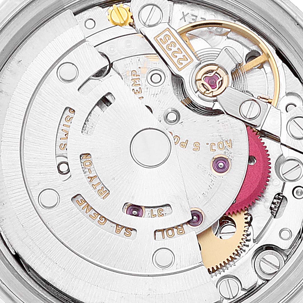 The image shows the intricate internal mechanism of a Rolex Datejust 79173 Women's Steel and Gold (two tone) Black Dial 79173 Women's Steel and Gold (two tone) Black Dial watch from a close-up angle, highlighting its movement components.