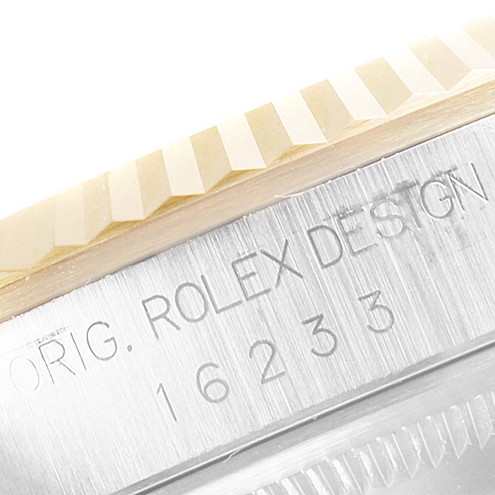 The image shows a close-up of the case side and fluted bezel of a Rolex Datejust 16233 Men's Steel and Gold (two tone) Champagne Dial 16233 Men's Steel and Gold (two tone) Champagne Dial model, displaying engraving details.