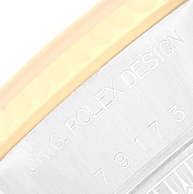 The image shows a close-up of the bezel and case side of a Rolex Datejust 79173 Women's Steel and Gold (two tone) Grey Dial 79173 Women's Steel and Gold (two tone) Grey Dial, highlighting the engraved "ORIG. ROLEX DESIGN 79173".