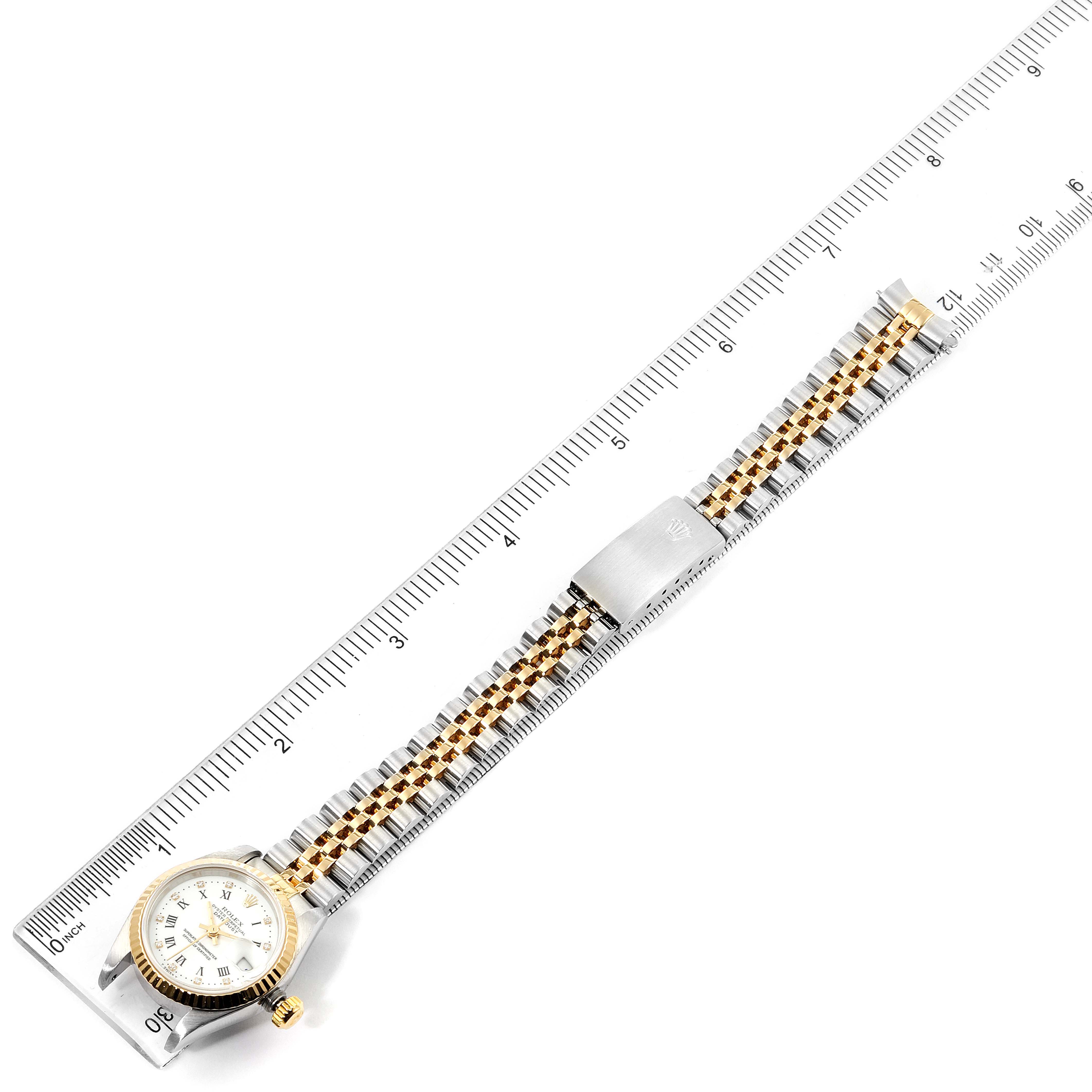 The image shows a top-down view of a Rolex Datejust 69173 Women's Steel and Gold (two tone) White Dial 69173 Women's Steel and Gold (two tone) White Dial watch, fully extended next to a ruler.