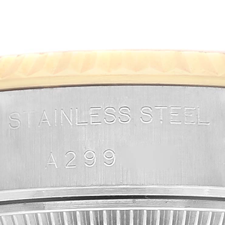 The image shows a close-up of the side of the case back of a Rolex Datejust 79173 Women's Steel and Gold (two tone) Silver Dial 79173 Women's Steel and Gold (two tone) Silver Dial watch, featuring stainless steel material and engraving.